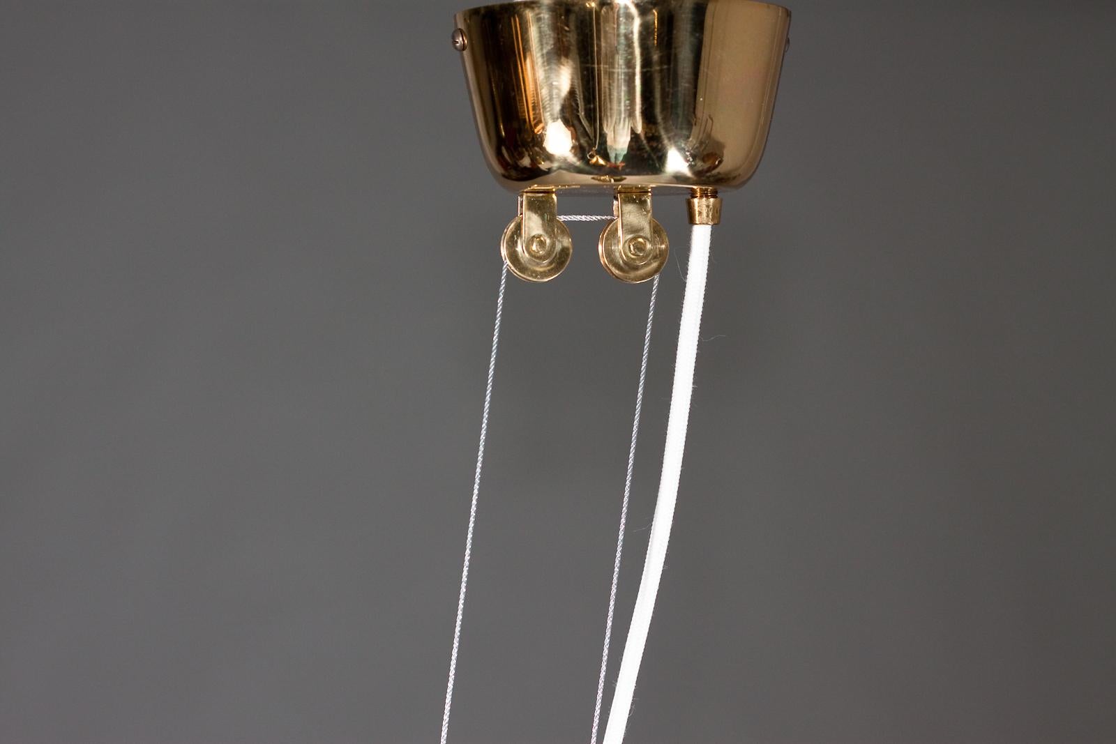 Paavo Tynell, pair of 1940's brass counterweight pendant lamps, Taito Oy In Good Condition In Turku, Varsinais-Suomi