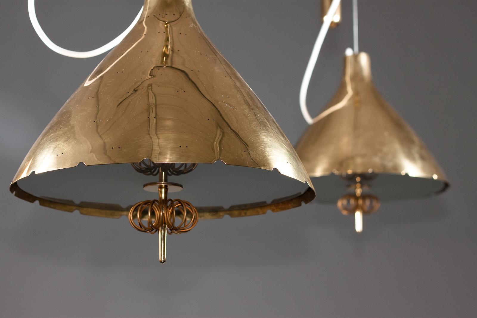 Paavo Tynell, pair of 1940's brass counterweight pendant lamps, Taito Oy 1