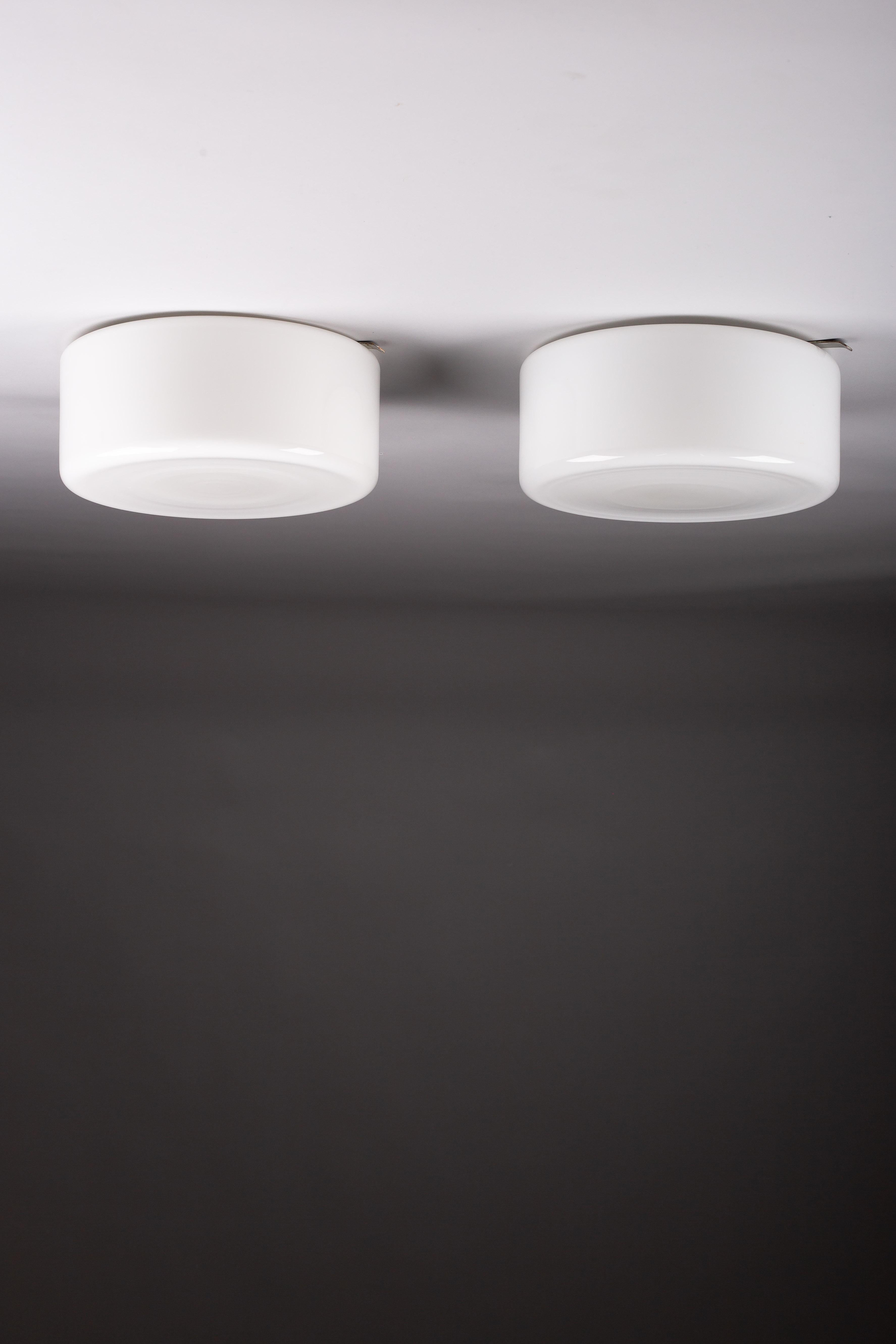 Discover the timeless elegance of Paavo Tynell’s pair of flush mounts from Idman Oy, an iconic addition to your hallway or other low spaces. These flush mount lamps are masterfully designed to provide both functionality and subtle sophistication,