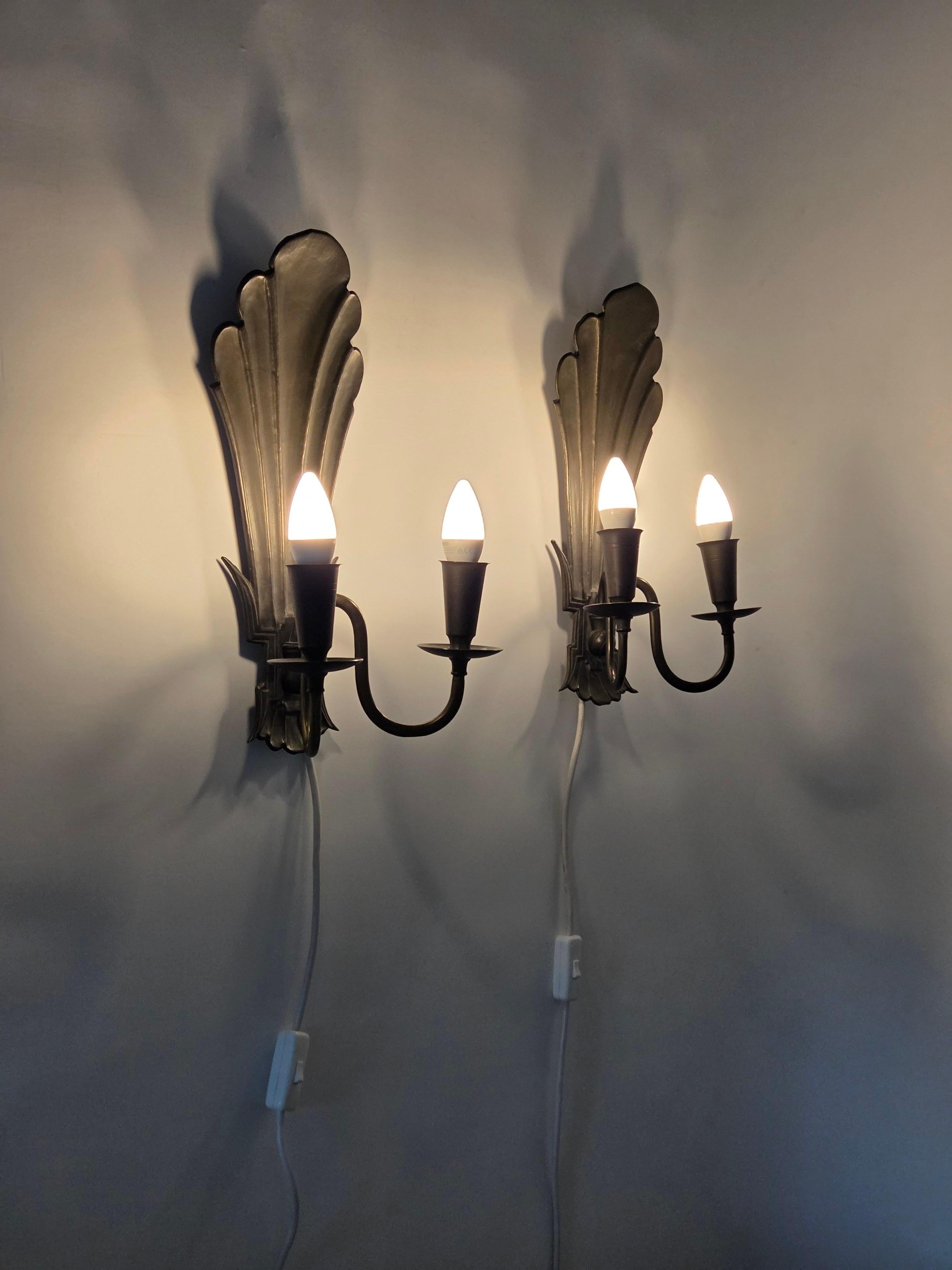 Pair of Wall Lamps Model 7004 designed by Paavo Tynell. The lamps are made of brass, and are in very good condition. 