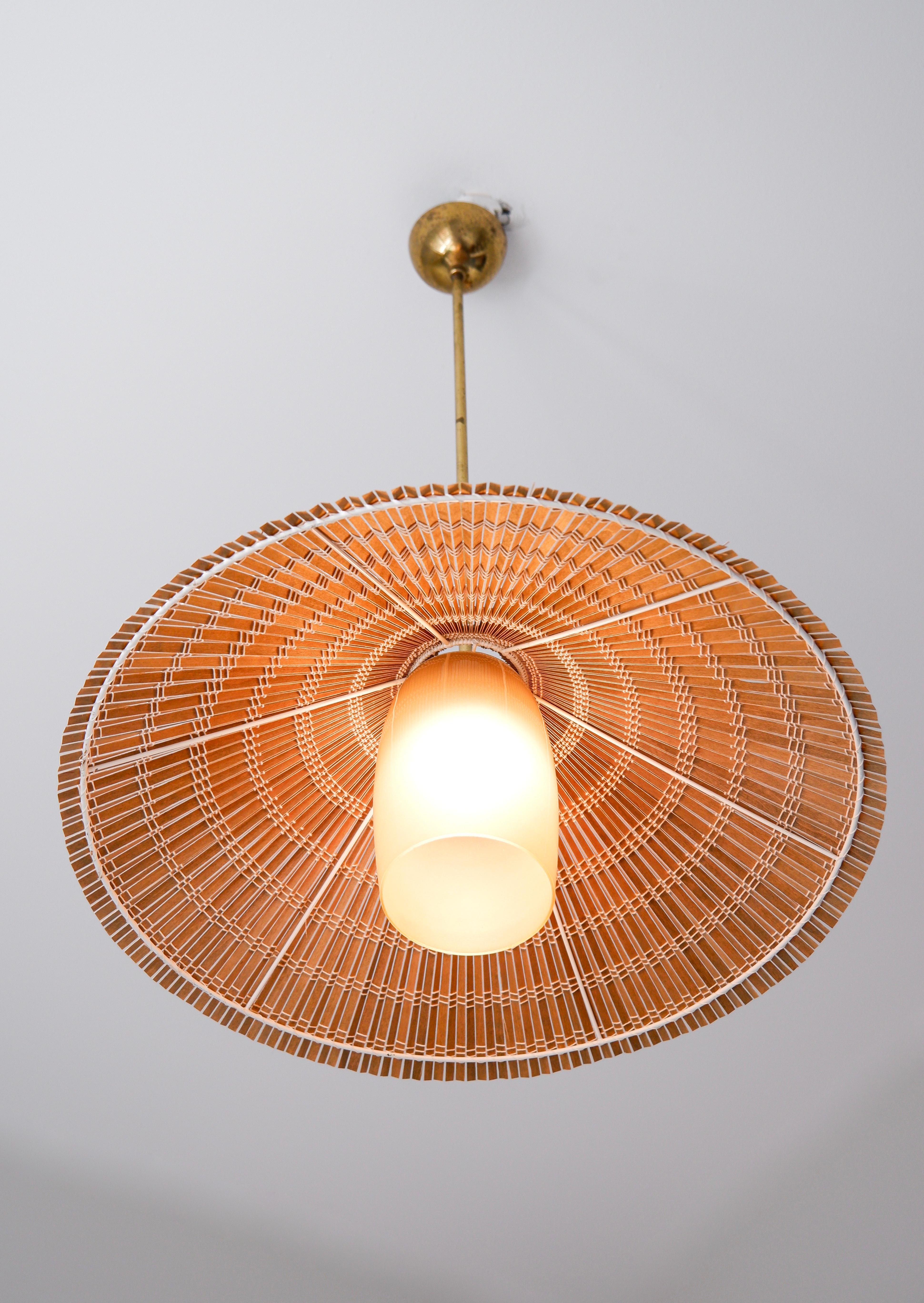 Large and nice Paavo Tynell Fixture model 1083 design in the 40's and produced during the 50's by TAITO in Finland. The light is composed by a Opal glass, a brass core and a rattan shade. The shade has been restored. Nice overhall condition. The