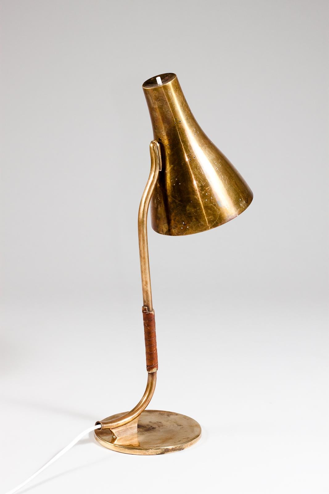 Introducing the Paavo Tynell rare 1940's desk lamp 9212, a true gem for vintage lighting enthusiasts. This exquisite lamp features Tynell's signature craftsmanship and attention to detail, with its elegant brass base and a delicate, cone-shaped