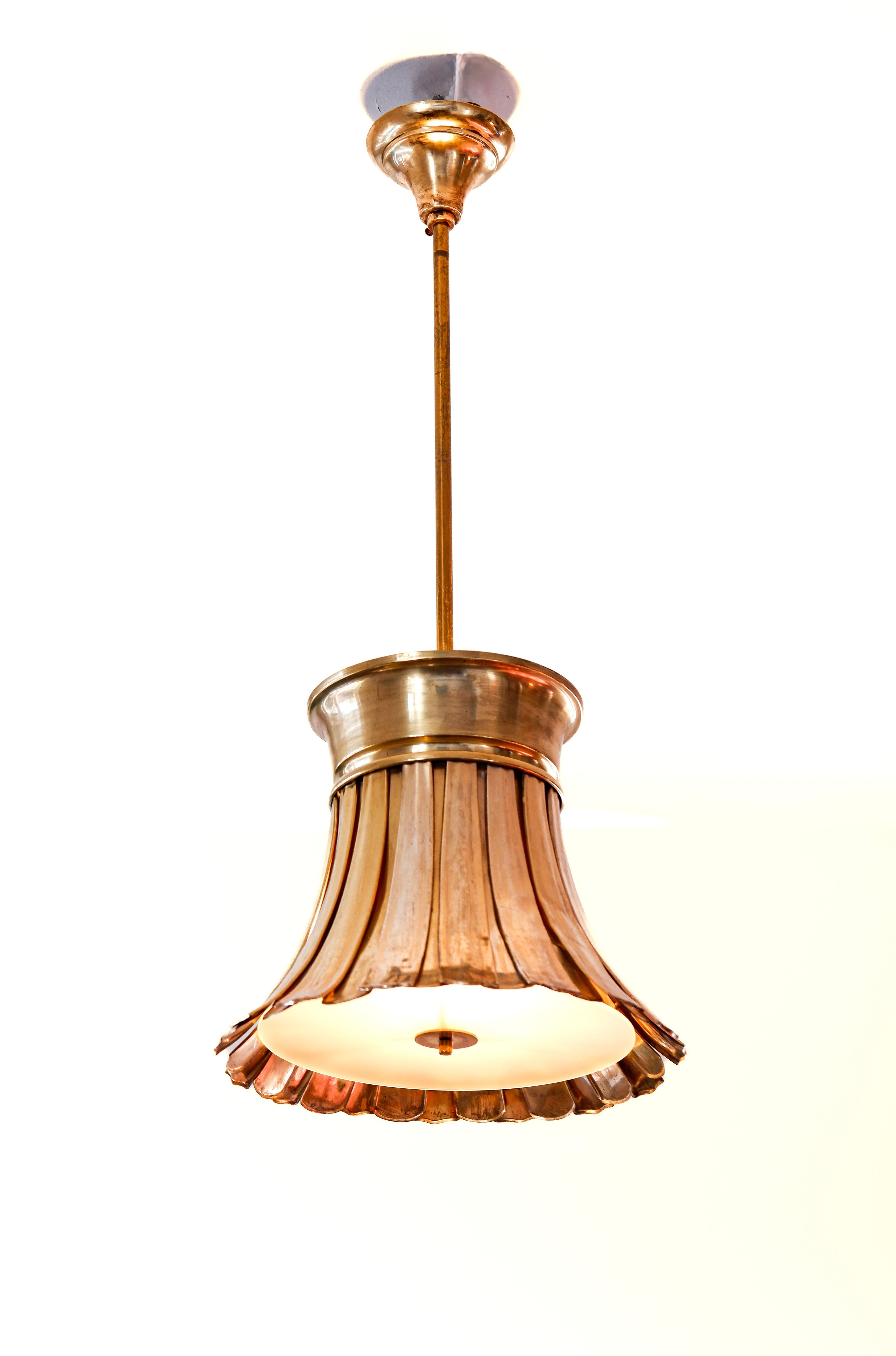Rare and early ceiling light designed by Paavo Tynell in the late 20's for the Finnish parliament and placed there in 1929. The light is made with long brass leafs putting upon each other. The light has a incredible electrical system on the top of