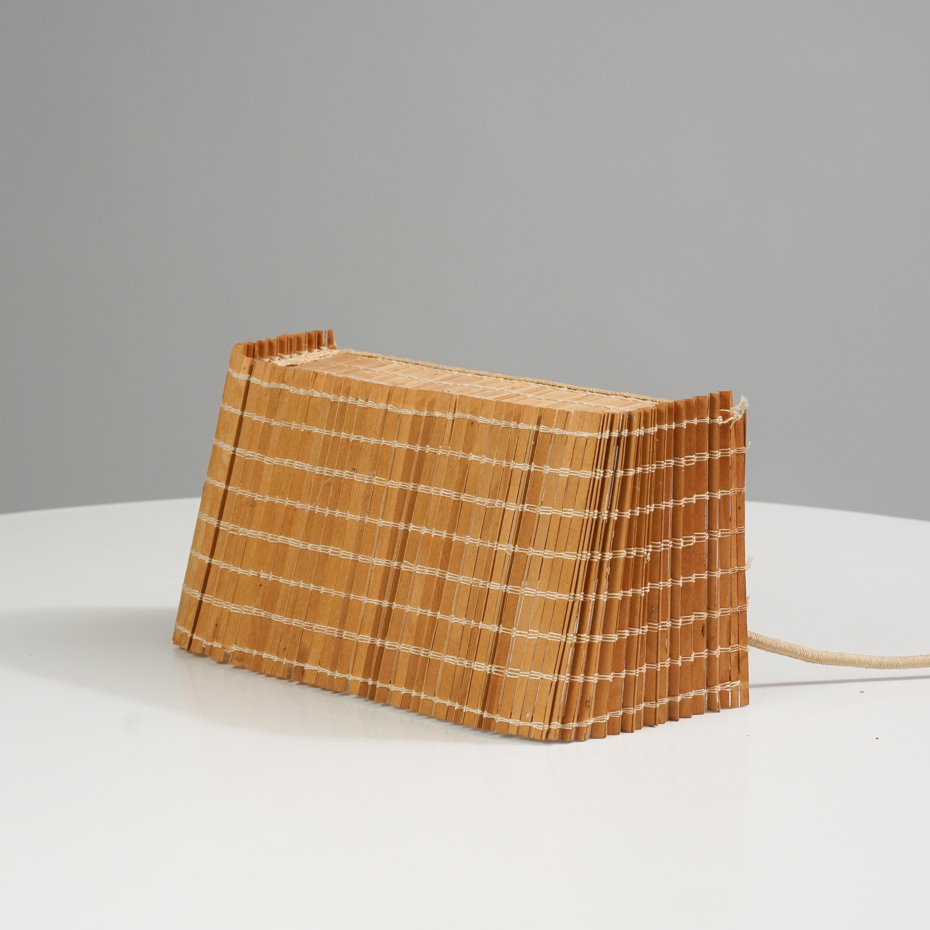 Stunning and rare wooden teak wall light by Paavo Tynell for Taito Oy from the  1950s. Minimalistic, yet stunning piece of design that gives you a beautiful light. All parts are original. Rewiring available by request. Included in the price.

Paavo