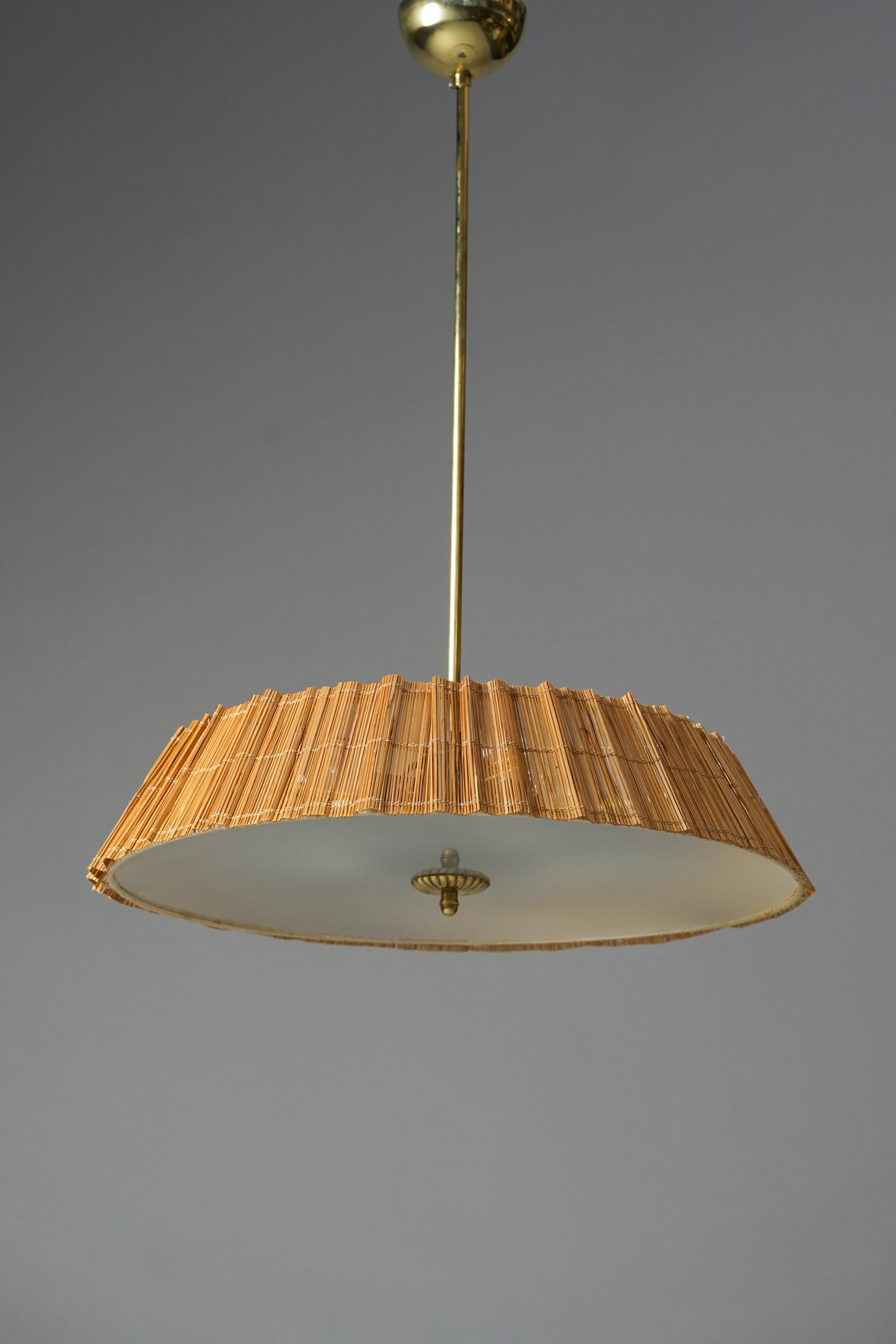 Gunnel Nyman Scandinavian Modern pendant for Taito Oy from the 1940s. Brass, glass and wooden slat shade. Good vintage condition. Minor wear consistent with age and use. A classic Gunnel Nyman pendant.