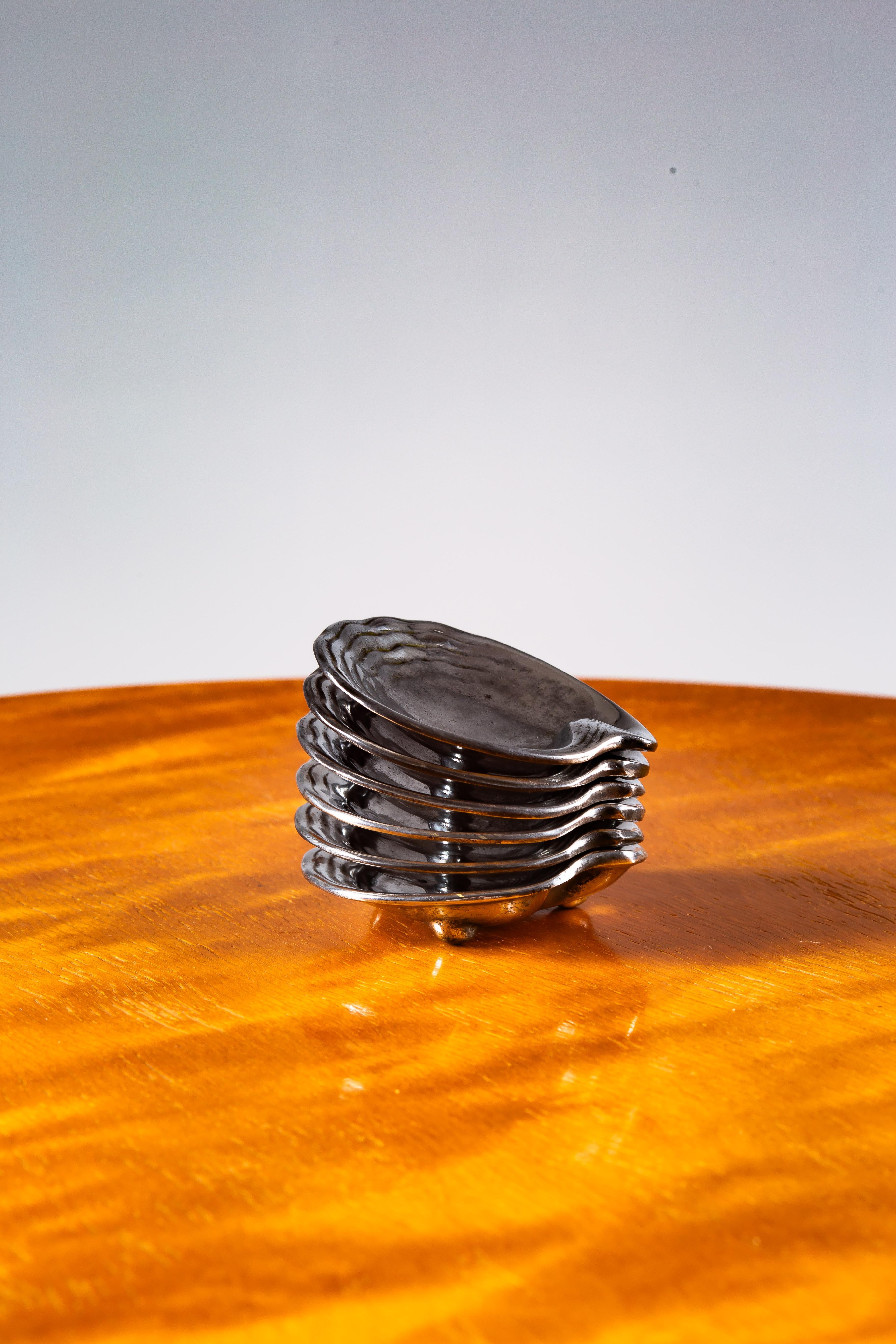 Discover the exquisite charm of this rare set of 1930's tinned small decorative trays by Paavo Tynell, crafted by Taito Oy, Finland. Each piece is a testament to the unparalleled craftsmanship and innovative design that define Scandinavian Vintage