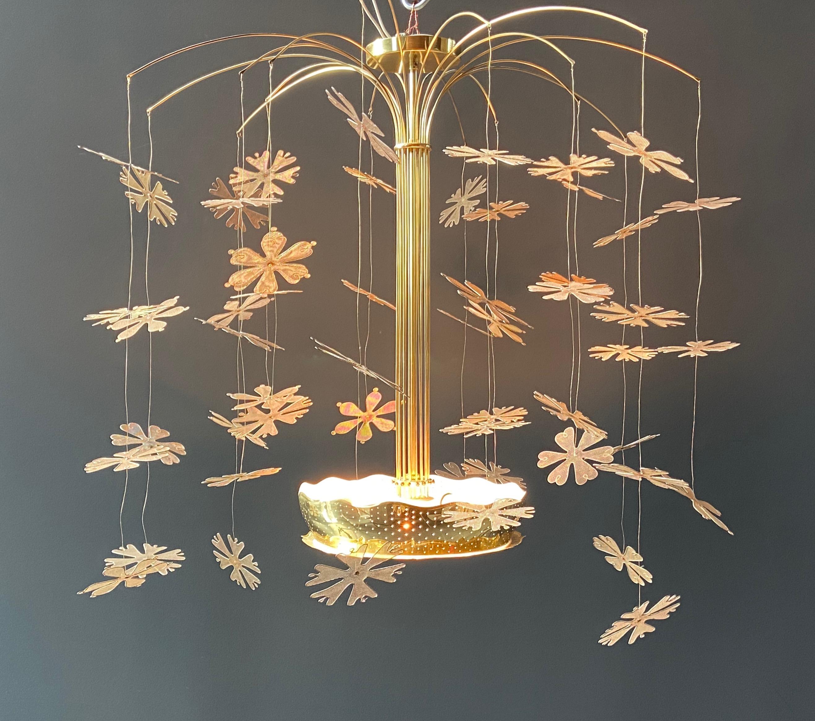 Rare Paavo Tynell snowflake brass chandelier model no. 9041 made by Taito Oy, circa 1950s. The multiple stems of this chandelier rise from a pierced brass bowl with 3-light and 16 arching branches that support 54 delicate brass mesh snowflakes (3