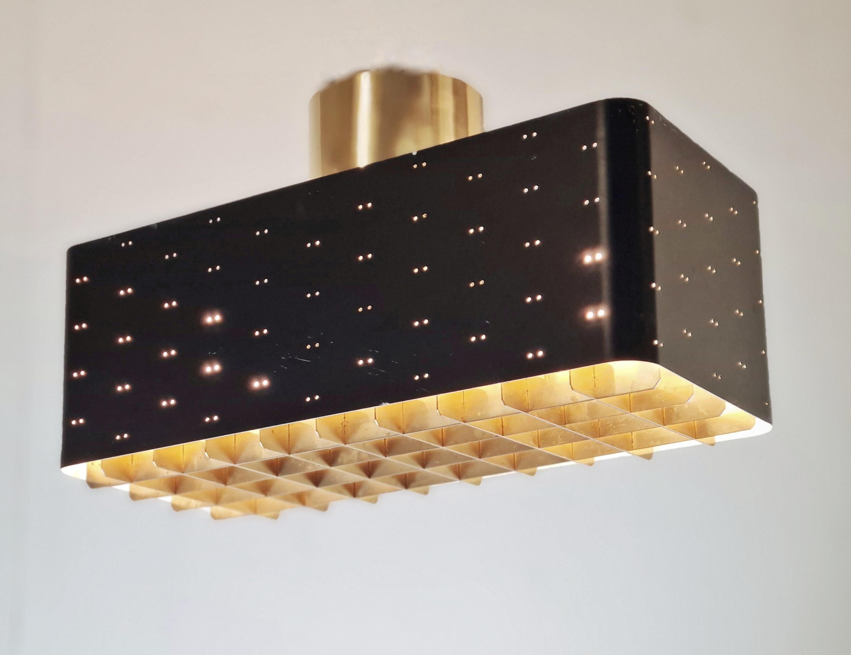 The Starry Sky is one of the most iconic design of Paavo Tynell's lamps. It's was made by both Taito and Idman in three different sizes. The way the light filters through the grill and the holes on the sides make the ceiling look like a starry sky.