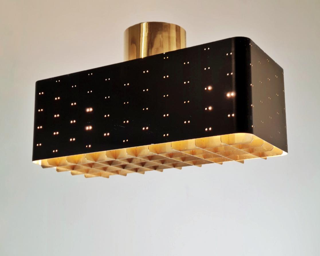 The Starry Sky is one of the most iconic designs of Paavo Tynell's lamps. It was made by both Taito and Idman in three different sizes. The way the light filters through the grill and the holes on the sides makes the ceiling look like a starry sky.