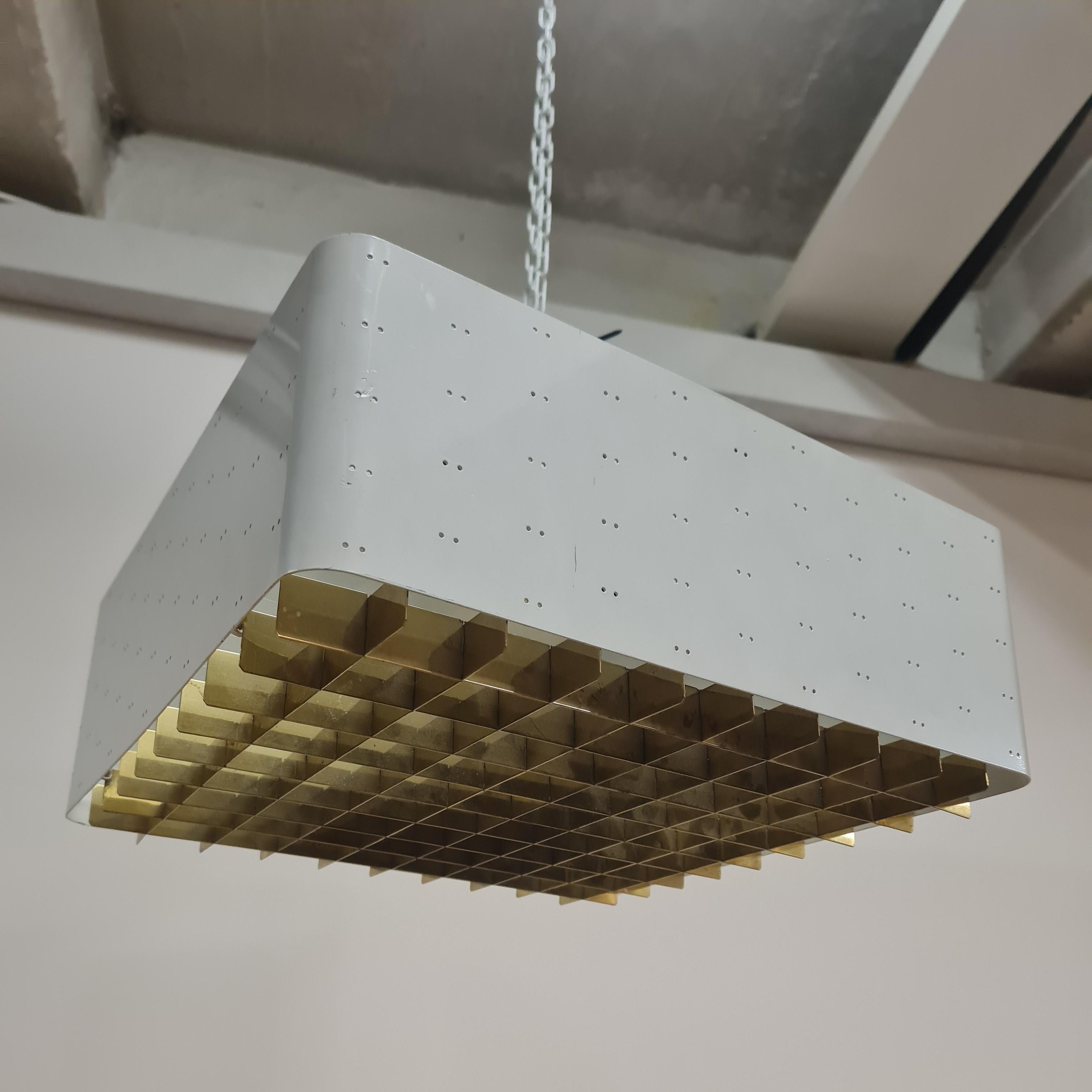The Starry Sky is one of the most iconic designs of Paavo Tynell's lamps. It was made by both Taito and Idman in many different sizes. The way the light filters through the grill and the holes on the sides makes the ceiling look like a starry sky.