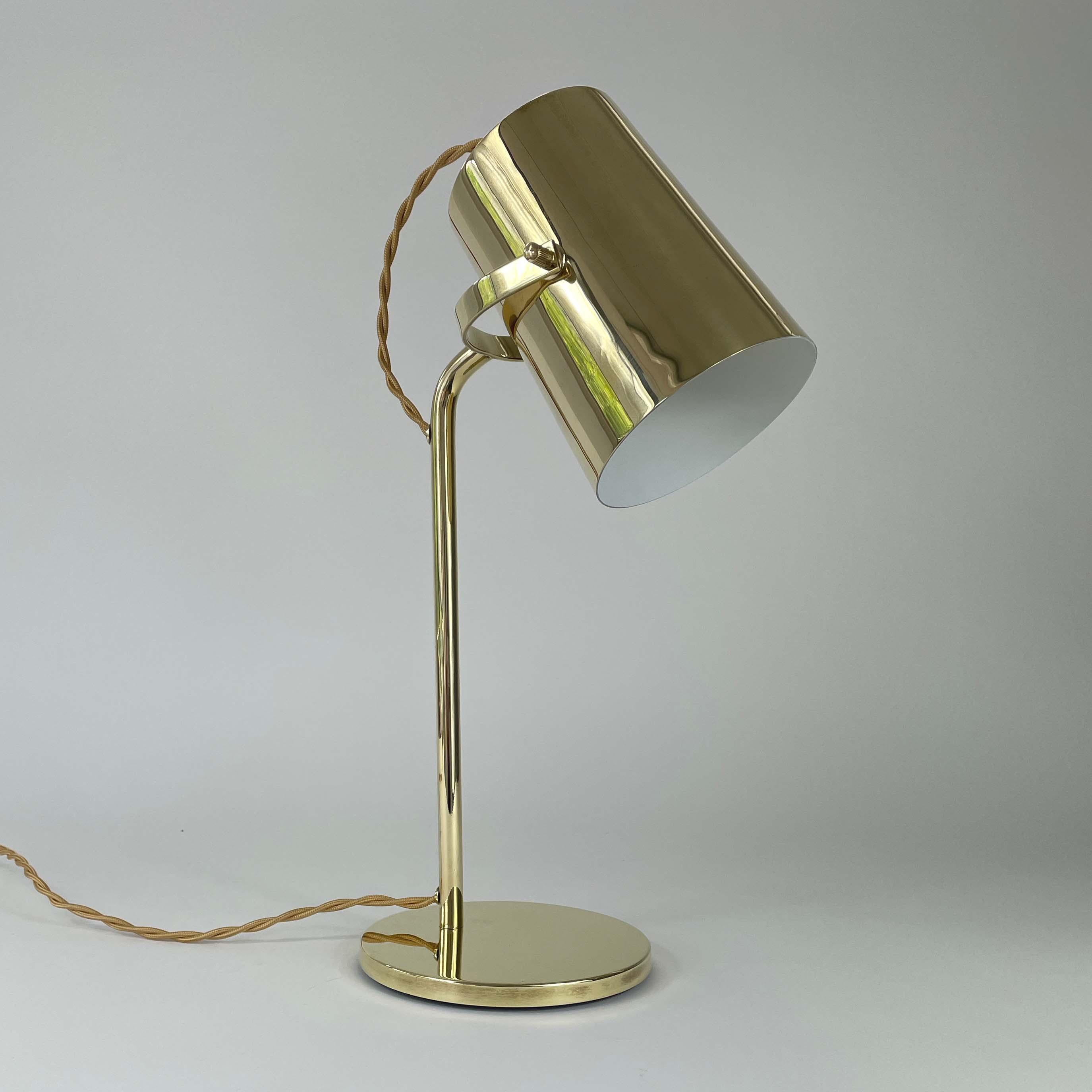 This unusual desk light was designed and manufactured in Finland in the 1940s to 1950s. It features an adjustable solid brass lampshade, brass lamp arm and brass base.

The light has been rewired with new gold colored silk cord and requires one E27