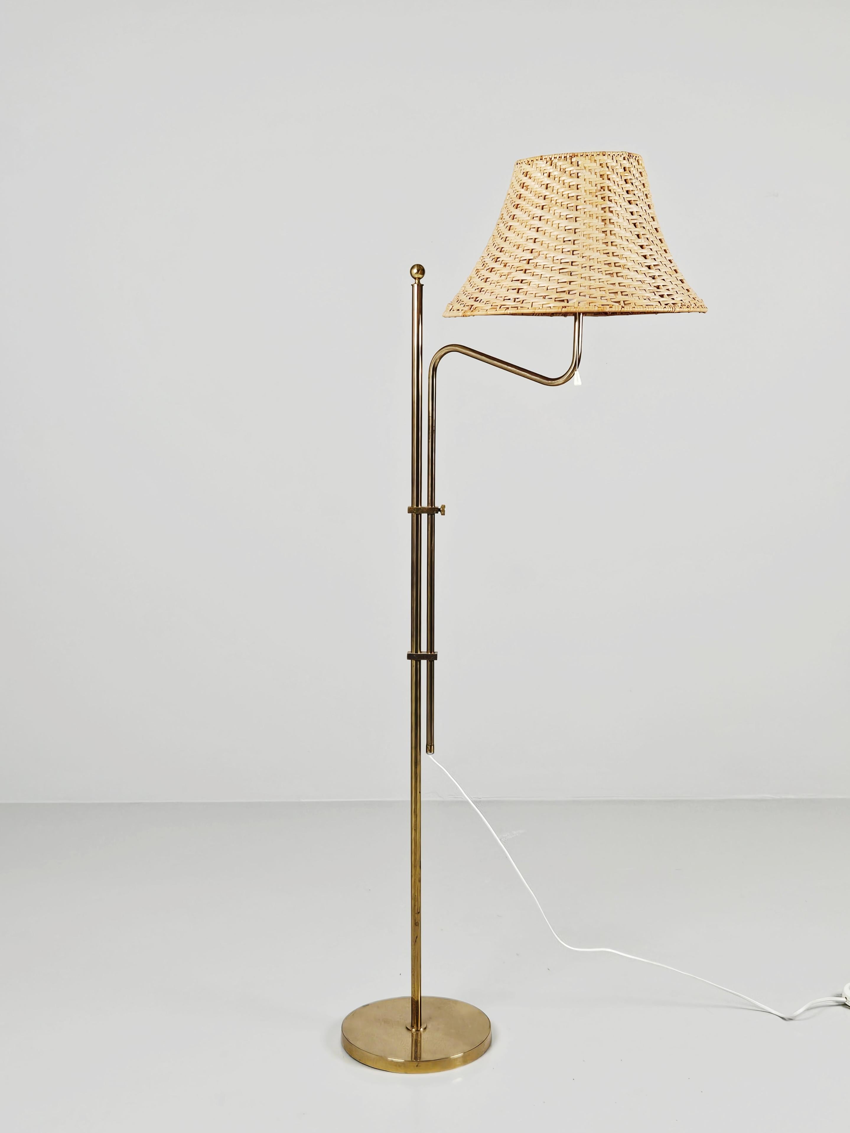 Beautiful brass floor lamp made by the Swedish company Bergboms during the 1960s. 

Adjustable height. Comes with a rattan shade. 