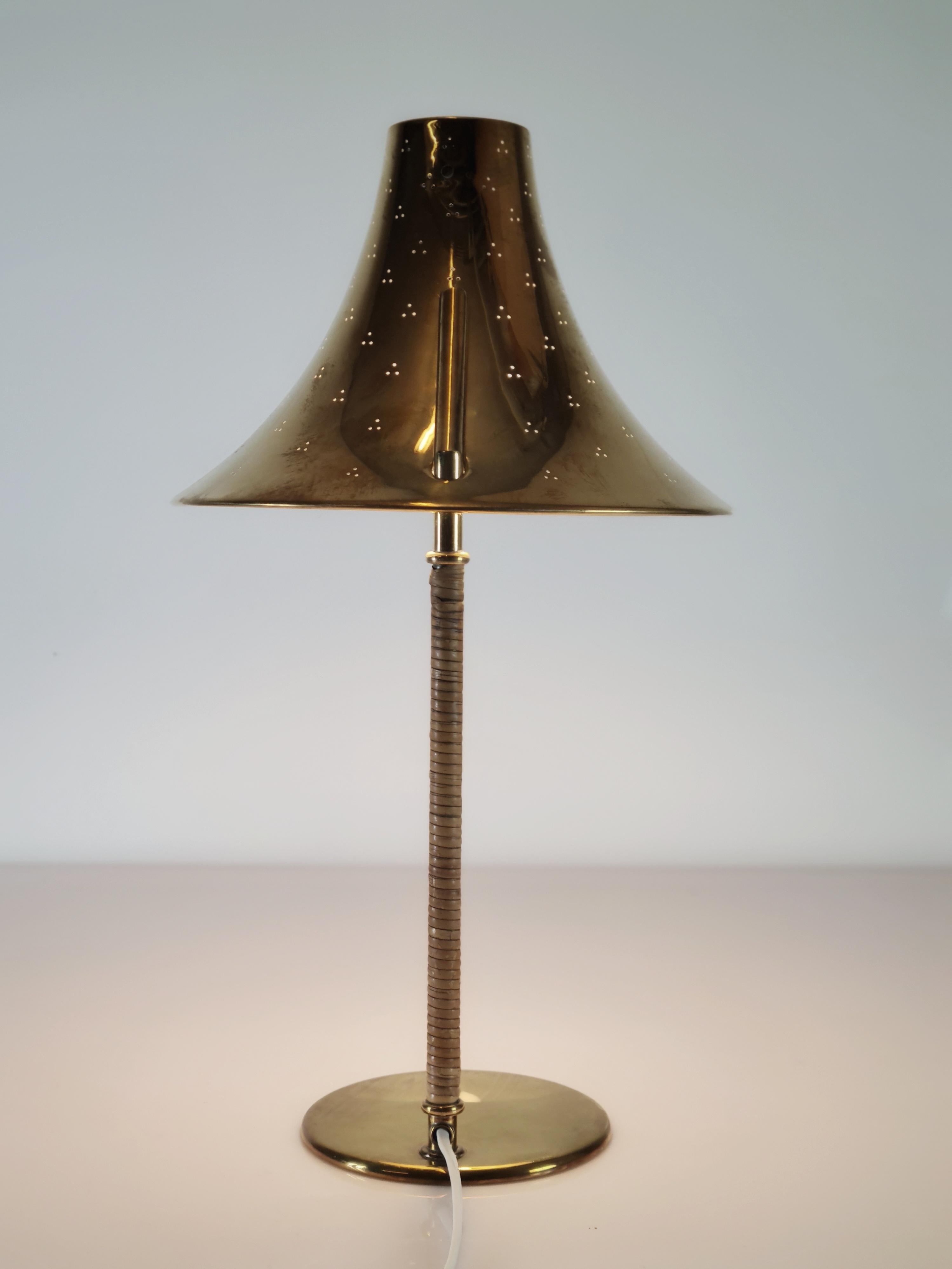 The distinctive reflector on this iconic Paavo Tynell table lamp gave it a few nicknames such as the cow's bell, church bell, hat lamp or even Snufkin after the character in the Moomins by Tove Jansson.

Part of the most sought after catalouged