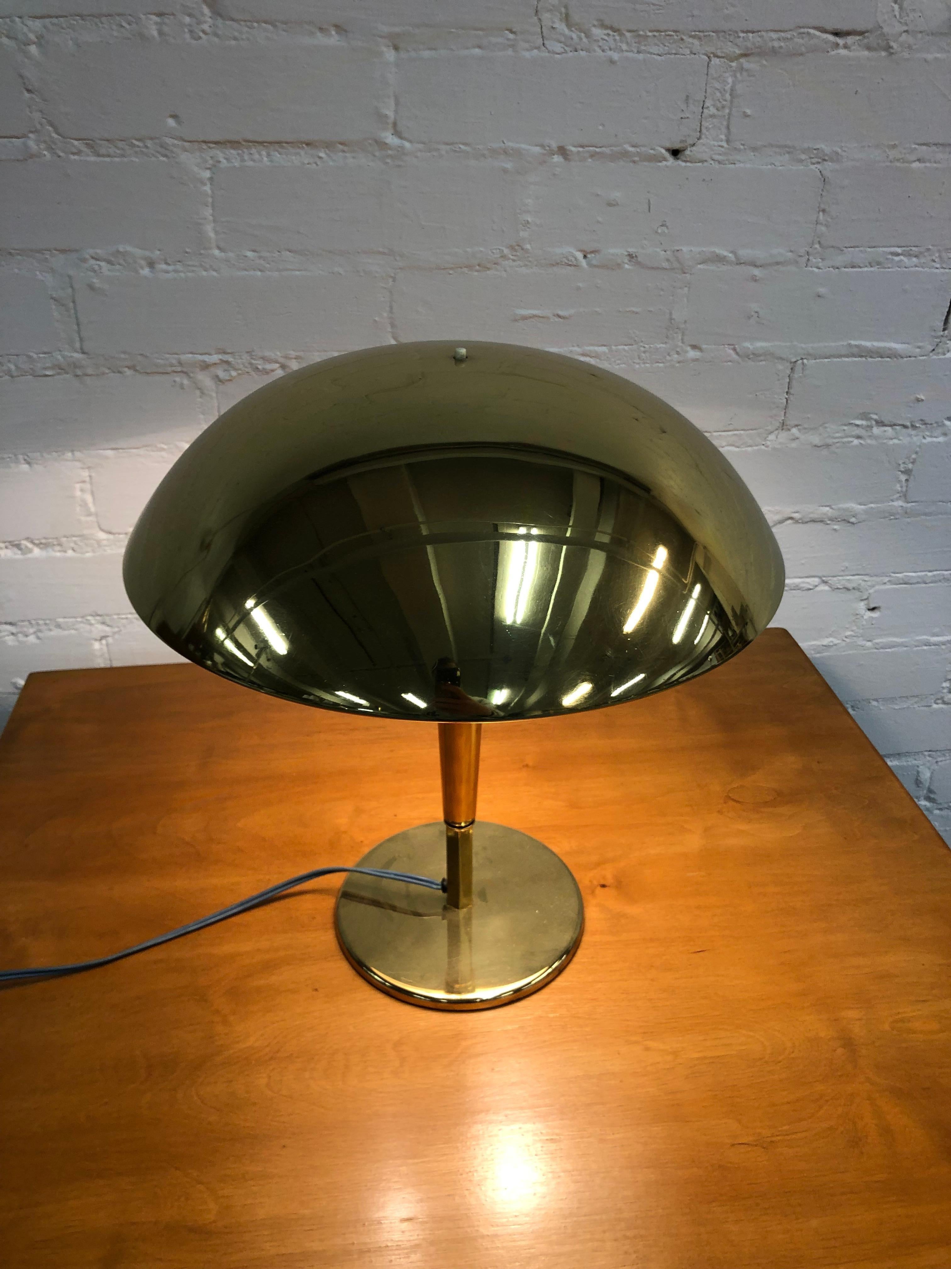 A more rare model of the 5061 table lamp in full brass, designed by Tynell and produced by Taito Oy in the 1940s.  This version is without the typical holes that Tynell used on the shade part of the lamp. 
The item is in very good condition and the