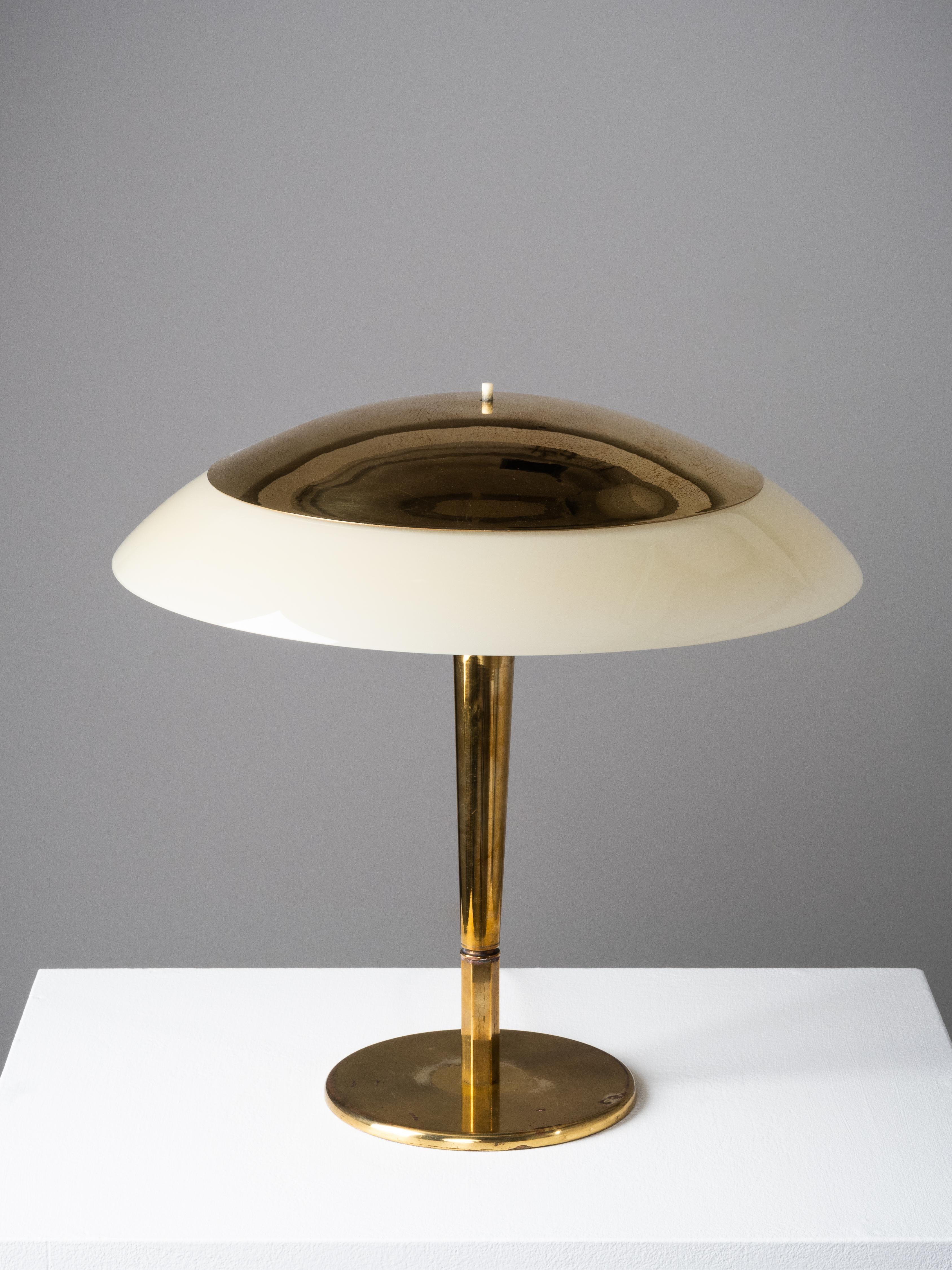 A refined and atmospheric table lamp by Paavo Tynell, Model 5061, produced by Taito Oy in the 1950s. Known among collectors as the “Umbrella Lamp,” this design showcases Tynell’s signature blend of sculptural brasswork and softly diffused