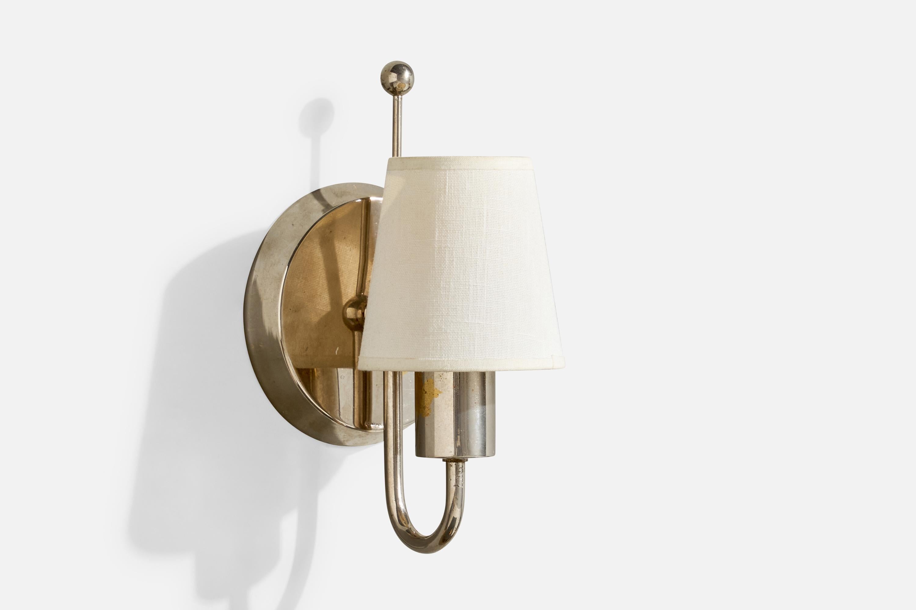 A nickel and white fabric wall light, model 7209, designed by Paavo Tynell and produced by Taito Oy, Finland, 1930s.

Overall Dimensions (Inches): 9.85” H x 5.25” W x 5.75“ D

Back Plate Dimensions (Inches): 5.25” H x 5.25“ W x 1” D

Bulb