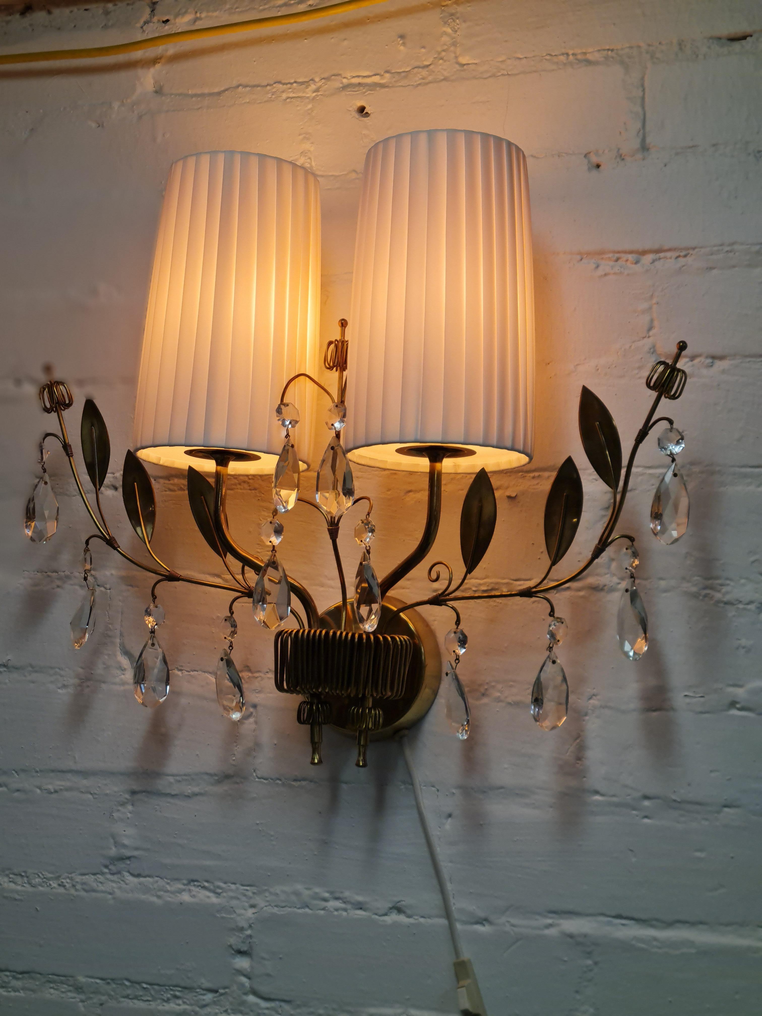 This pair of wall lamps shows Paavo Tynells genious as a designer.  The attention to detail is quite evident as every small detail is well thought of to bring about such beautiful wall lamps.
These would fit easily in all sorts of living rooms and