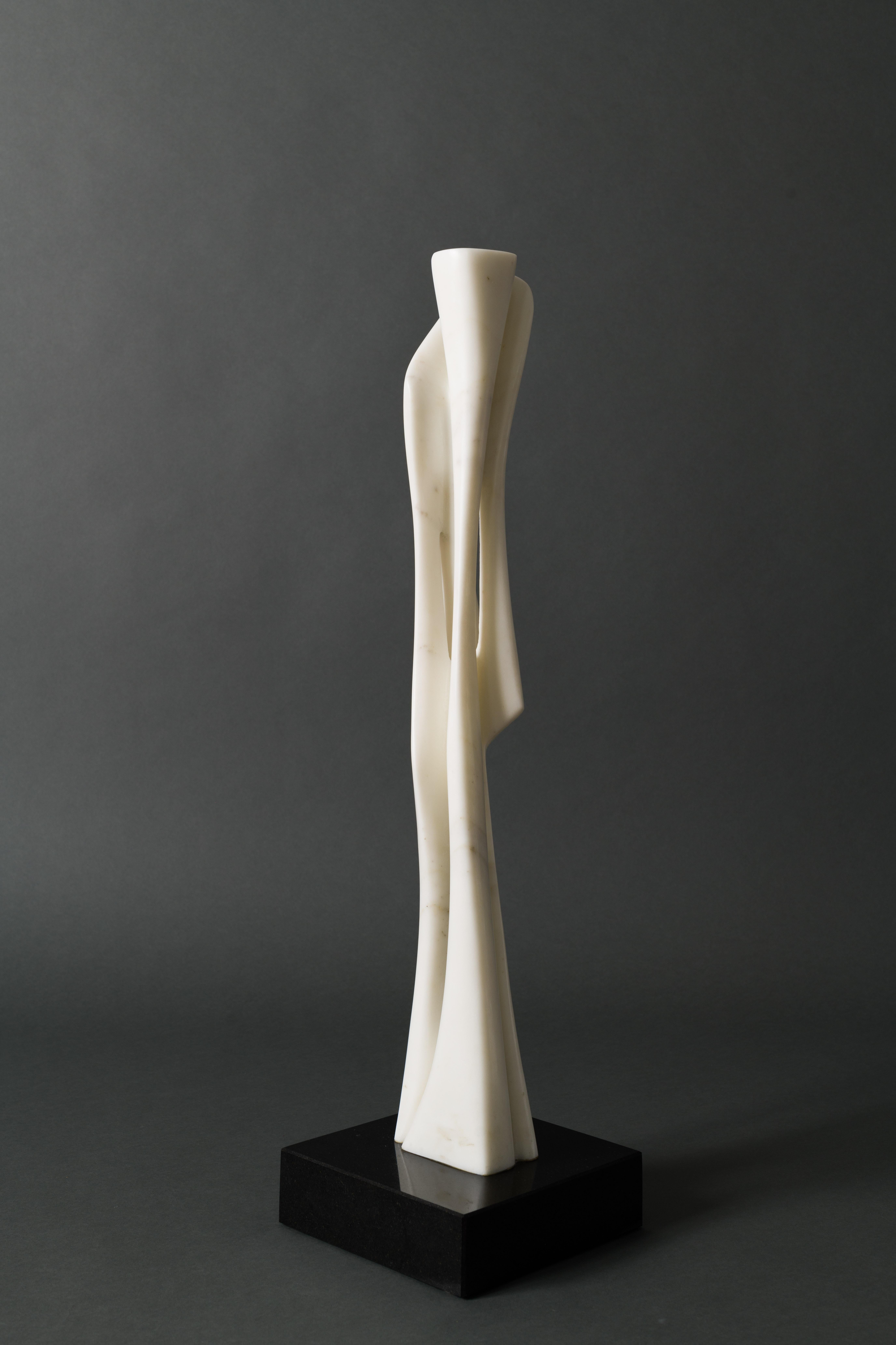 Untitled, 2000 – 2012 is a unique and special composition by the sculptor.  Instead of letting myriad folds be the focal point, it is the verticality and beauty of the stone and its negative space which are at play here.  Making it less a formulaic