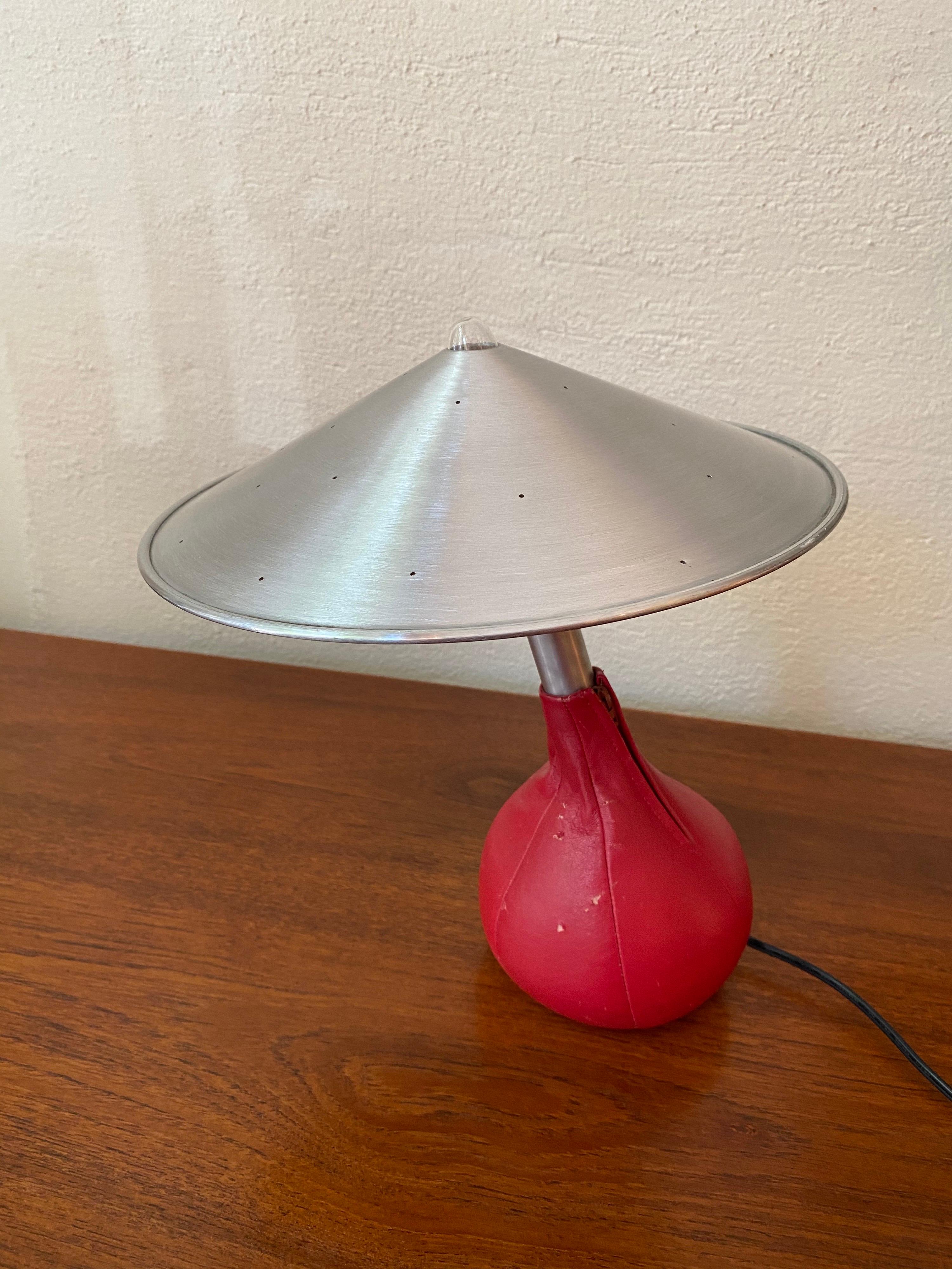 Pablo Pardo designed Piccola bean bag table lamp with aluminum shade. Shade sits on bulb. Nice glow through the pin holes in the shade. Can position in multiple positions. Heavy bean bag sits very solid.