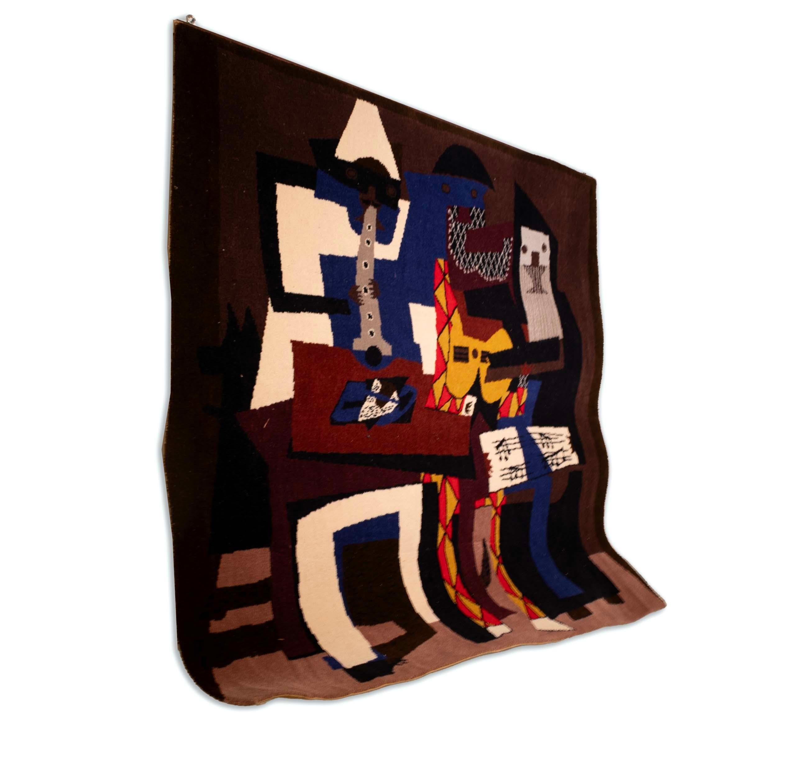 A rare, limited-edition rug or wall hanging featuring the famous Pablo Picasso painting “Three Musicians (Musicos con mascaras) 1921.” The original painting is currently on display at the Museum of Modern Art in New York. On verso is an annotation