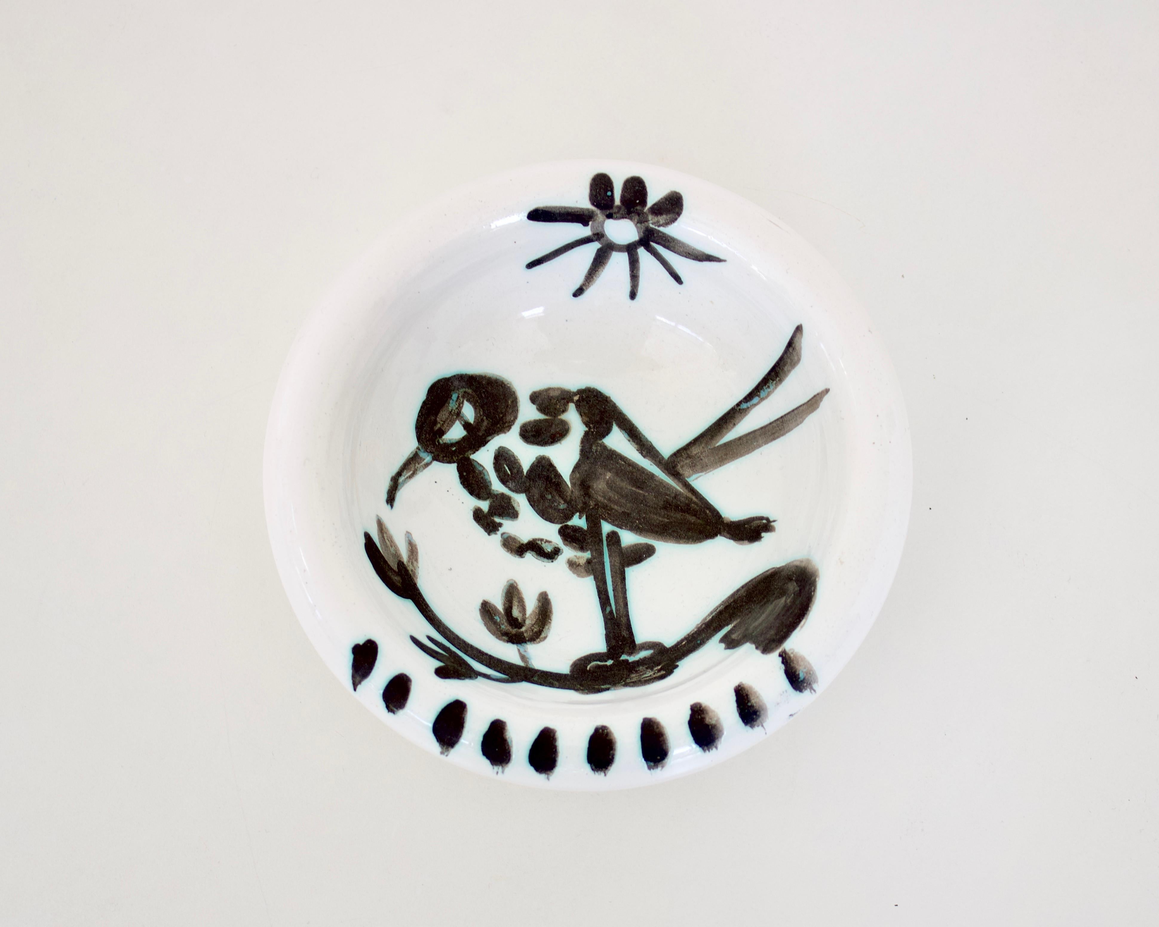 Pablo Picasso Oiseau dish bird with sun, editions Picasso Madoura France, circa 1952. 15 hand painted brush strokes under the birds feet referring to food. 
Impressed with mark to underside Madoura Plein Feu edition Picasso and also with edition