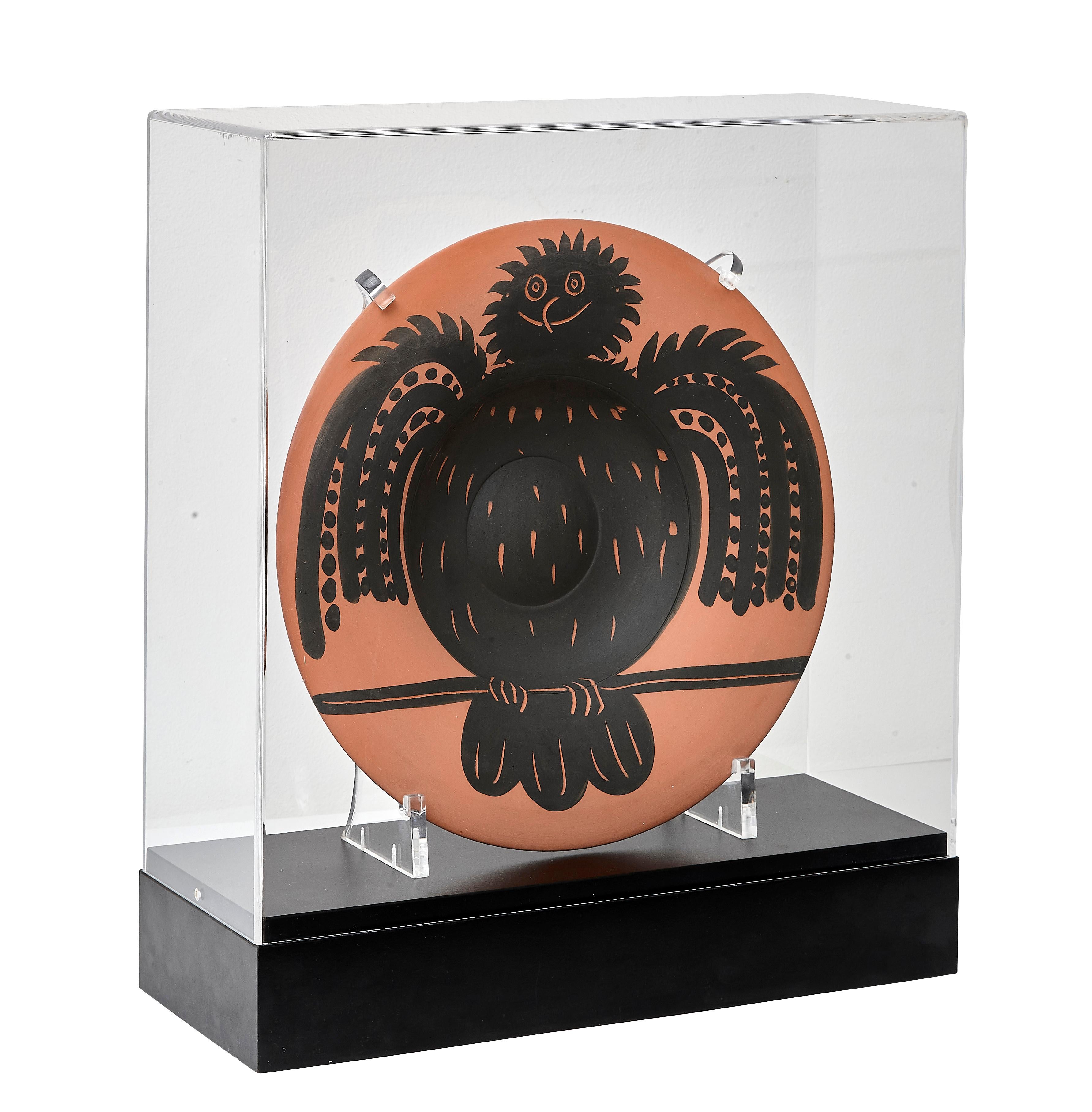 PABLO PICASSO (1881-1973) 
Hibou noir perche (A. R. 398) 

Terre de faïence dish, painted, 1957, numbered 33/100 and incised 'N 104', with the Edition Picasso and Madoura stamps.