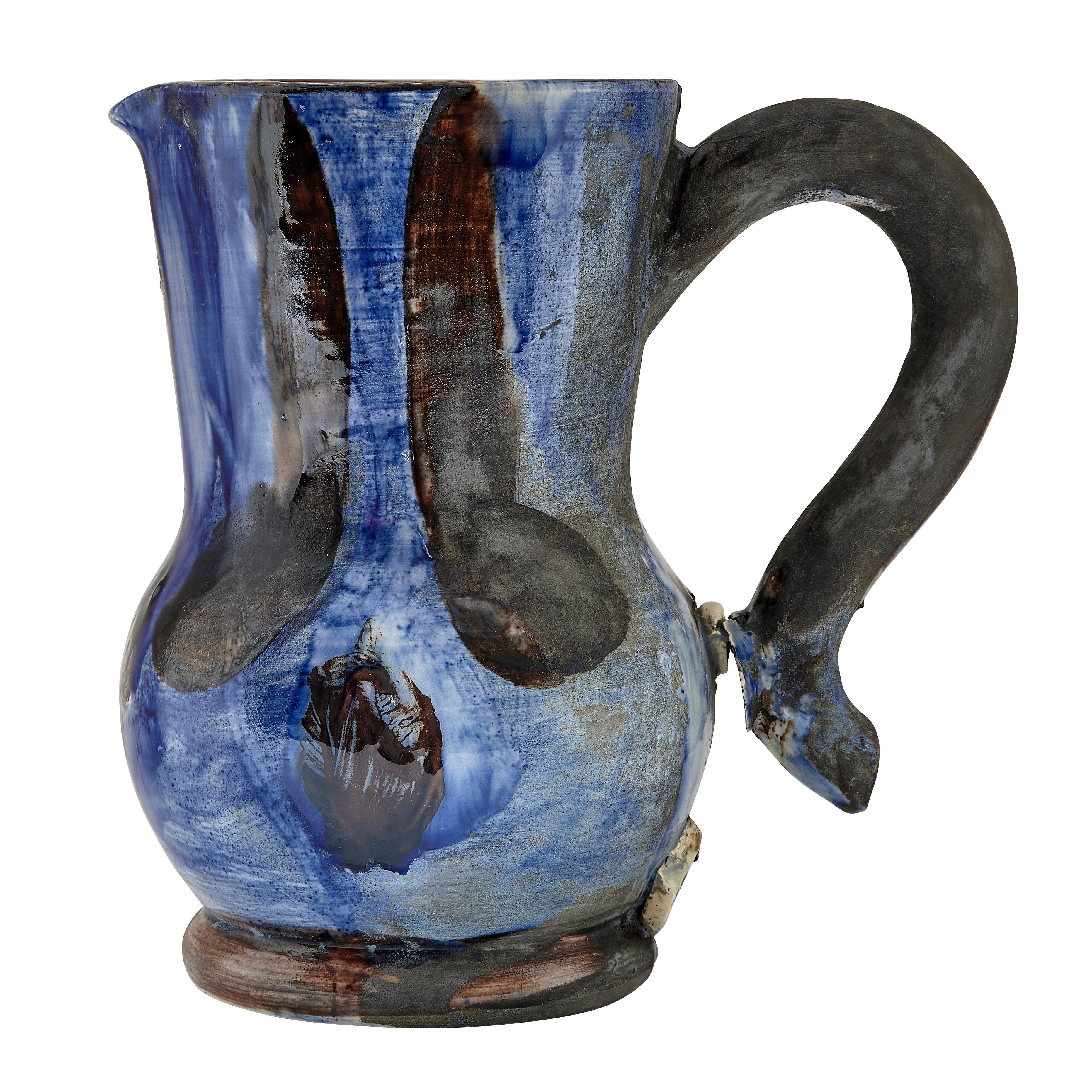 PABLO PICASSO (1881-1973) 
Pichet bleu et brun (Unique) 

White earthenware ceramic pitcher with colored engobe and glaze, stamped 'Madoura Plein Feu' (underneath). Executed in 1954; this work is unique. Claude Picasso has confirmed the authenticity