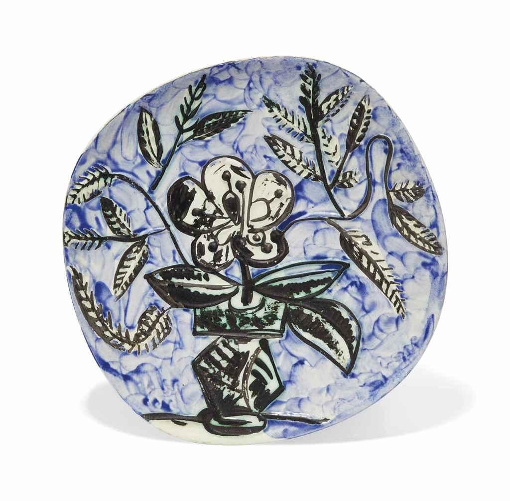 This Picasso ceramic plate "Vase Au Bouquet  Ramié 304" is one in an edition of 200 and is made of white earthenware clay, and decorated with colored engobes and glaze.   

Please contact us with any questions.