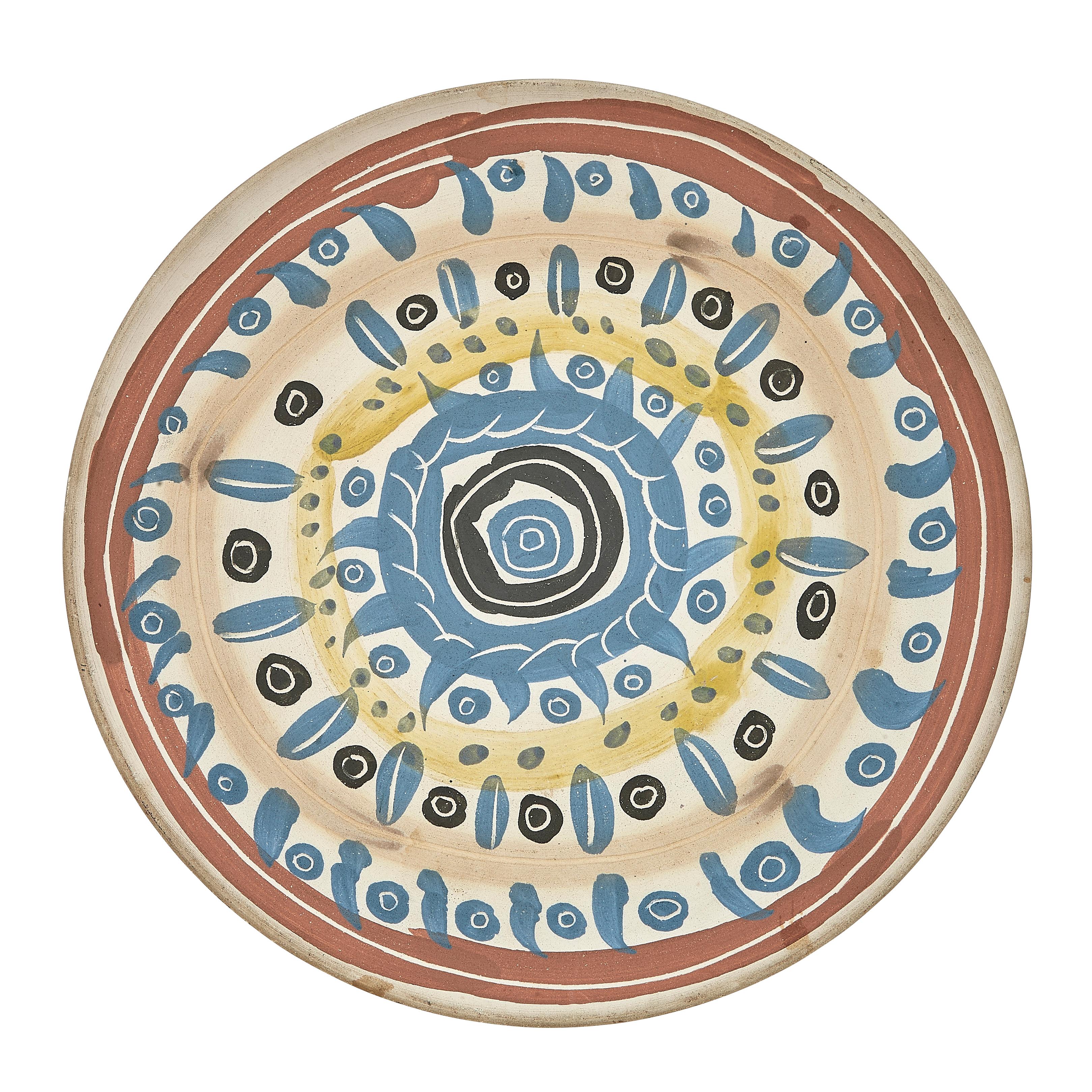 PABLO PICASSO (1881-1973) 
Motif spiralé (A. R. 404)

Terre de faïence plate, 1957, numbered 71/500, with the workshop numbering, incised 'Edition Picasso' and 'Madoura', partially painted, with the Edition Picasso and Madoura stamps.