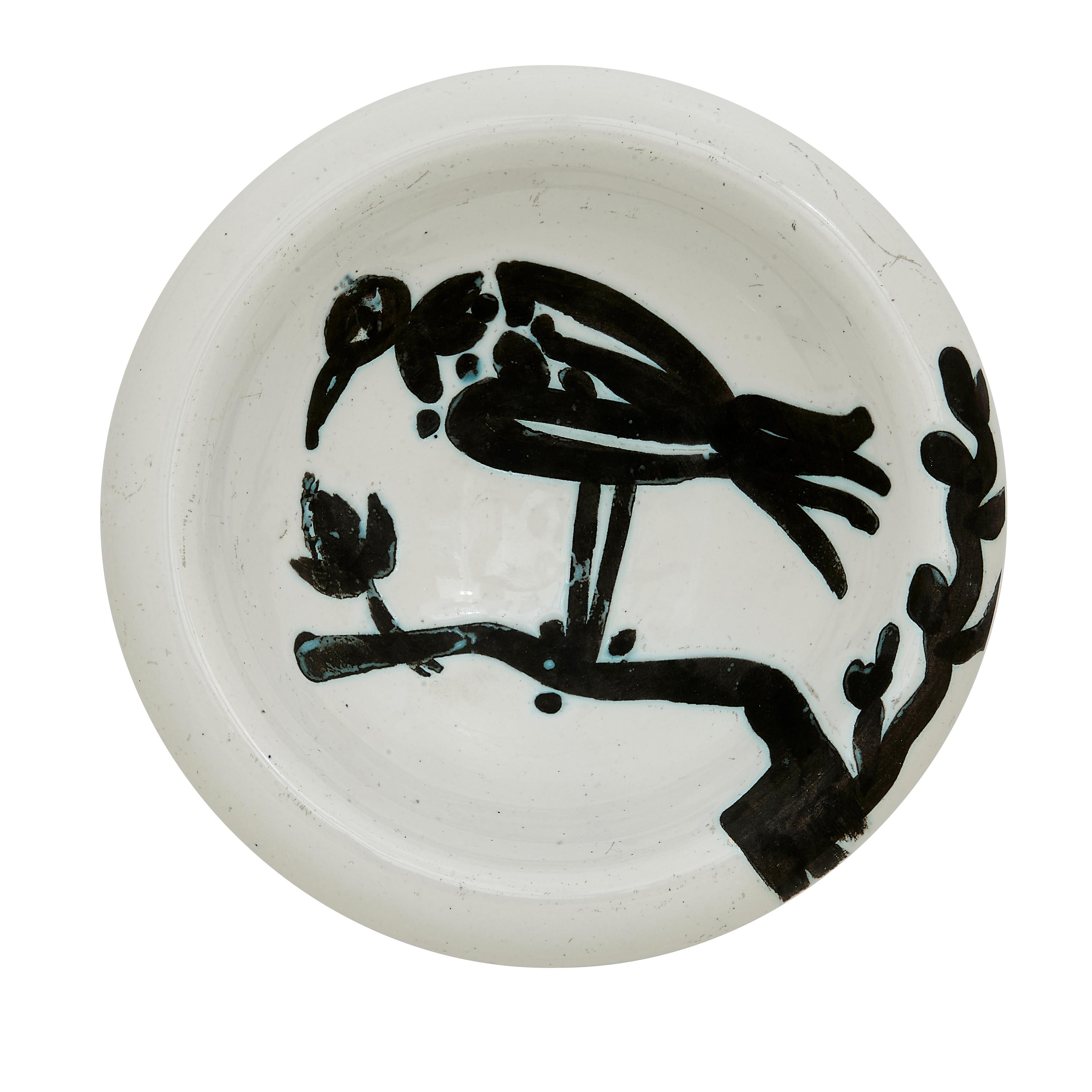 PABLO PICASSO (1881-1973) 
Oiseau sur la branche (A. R. 175) 

Terre de faïence ashtray, painted and partially glazed, 1952, from the edition of 500, inscribed 'Edition Picasso', with the Edition Picasso and Madoura stamps.