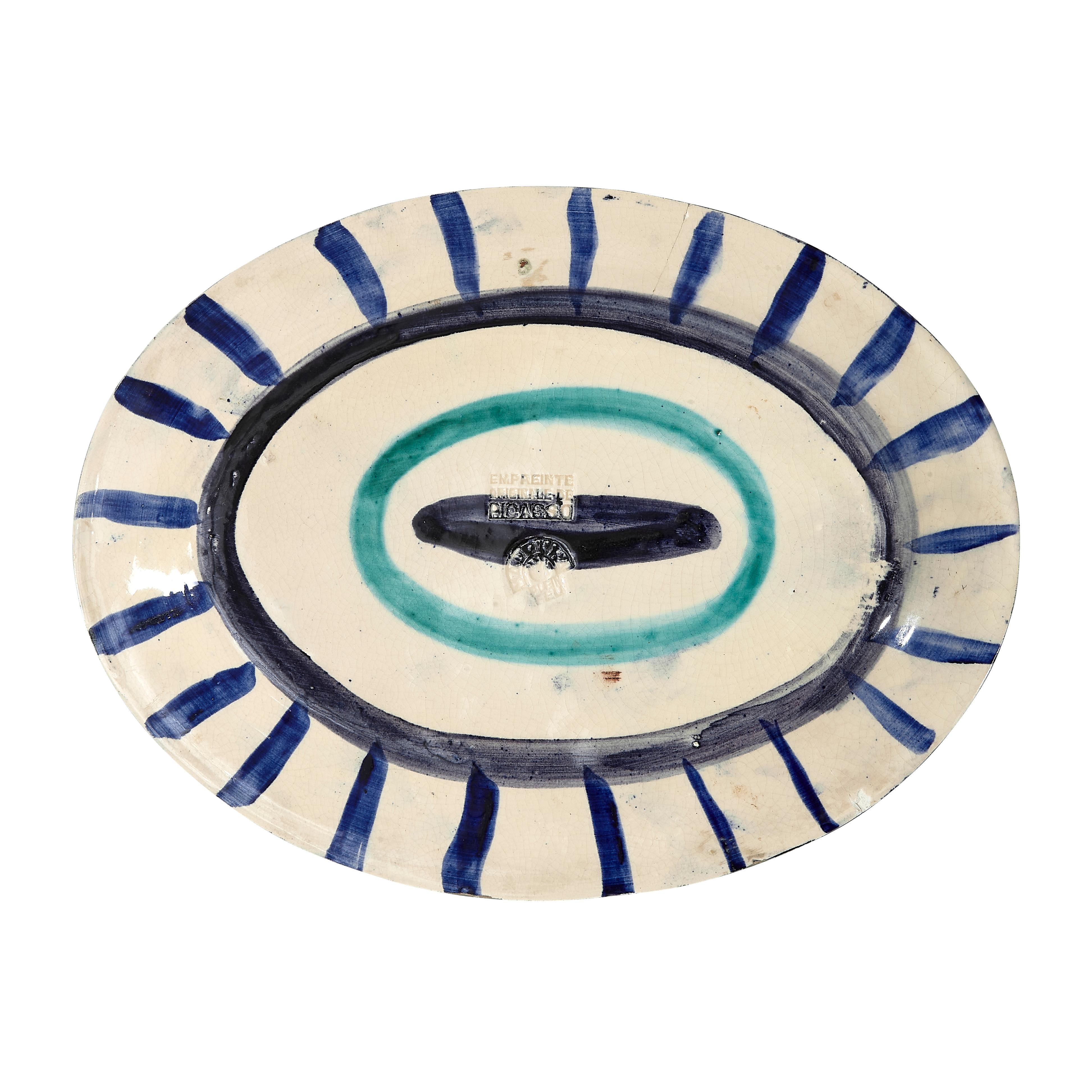PABLO PICASSO (1881-1973) 
Poisson de profil (A. R. 131) 

Terre de faïence plate, painted in colors and glazed, 1951, from the edition of 25, with the Empreinte Originale de Picasso and Madoura stamps.