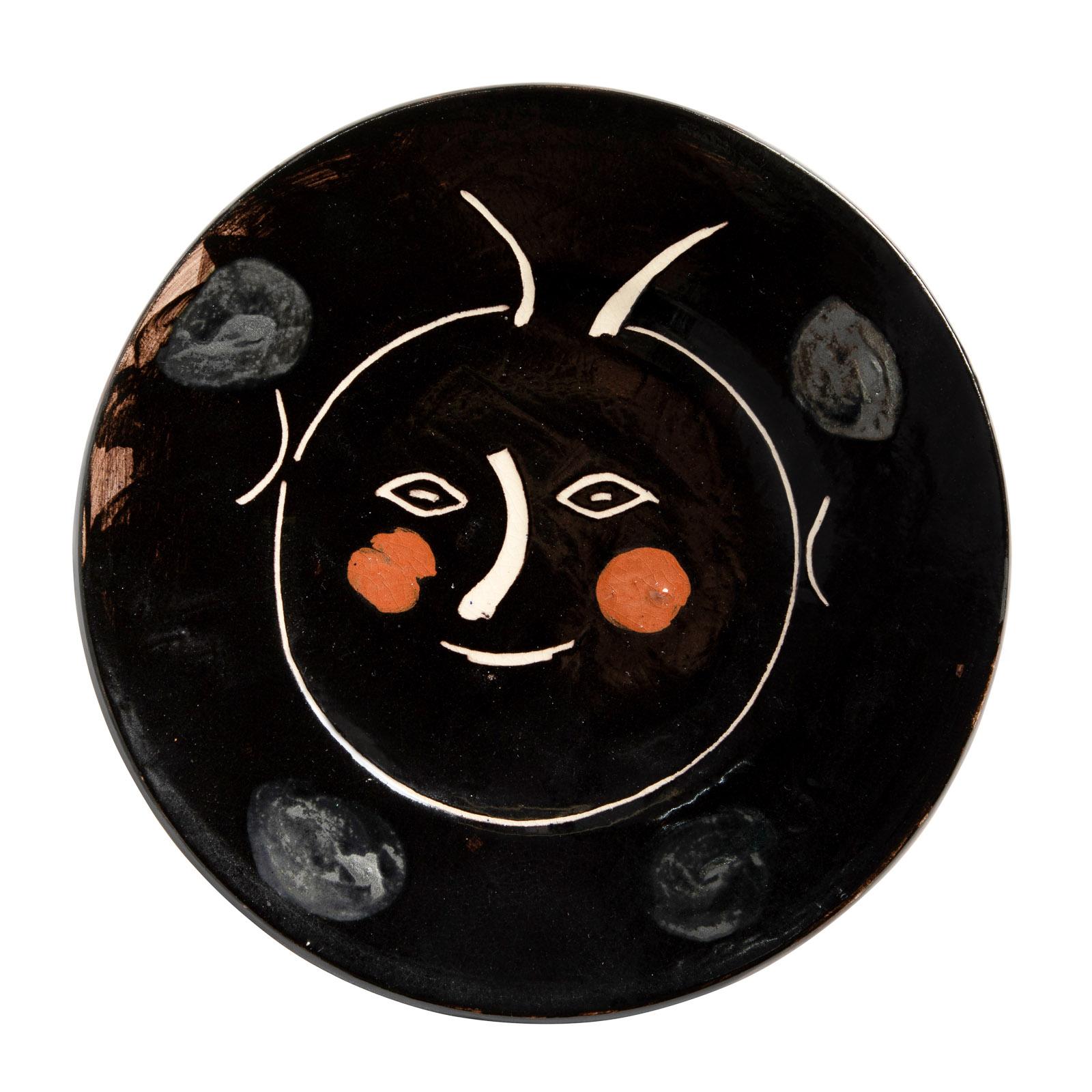 PABLO PICASSO (1881-1973) 
Service visage noir (A. R. 38)

Terre de faïence plate, 1948, titled, from the edition of 100, inscribed 'Madoura' and 'd'aprés Picasso', glazed and painted, with the Madoura stamp.