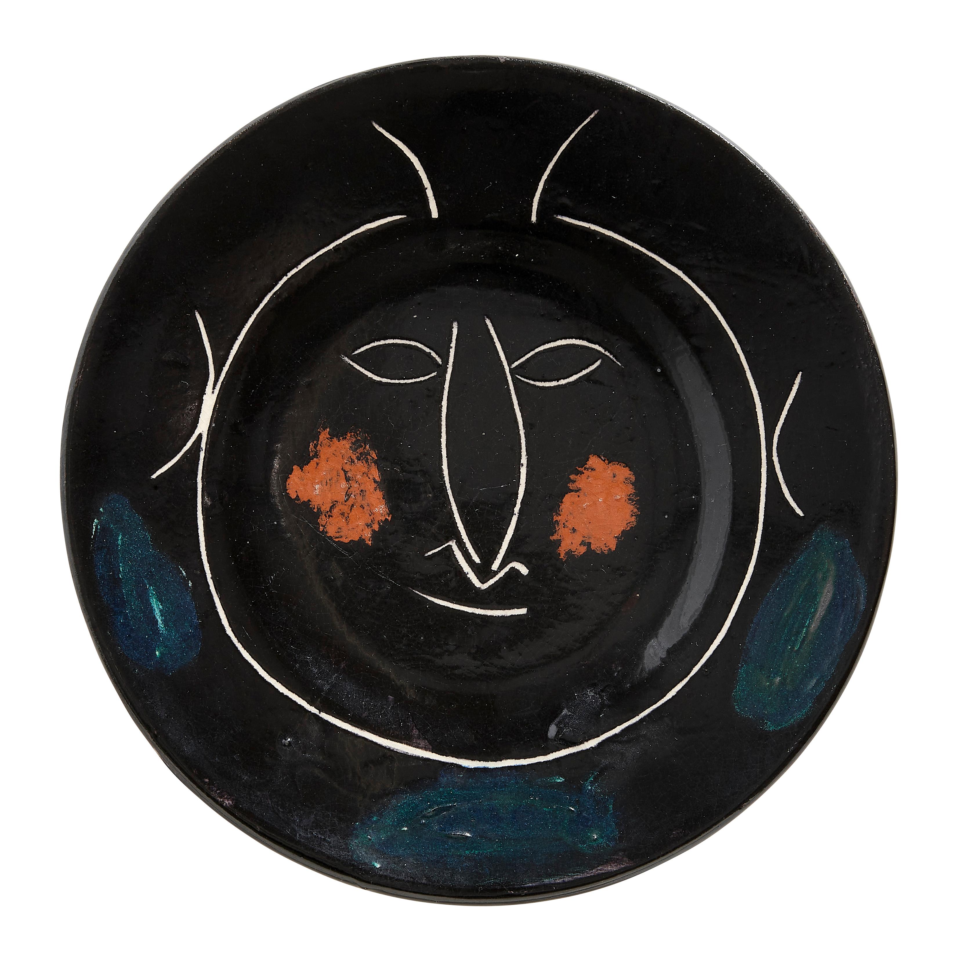 PABLO PICASSO (1881-1973) 
Service visage noir (A. R. 43)

Terre de faïence plate, painted in colors and glazed, 1948, from the edition of 100, inscribed 'H', 'd'après Picasso' and 'Madoura', with the Madoura stamp.