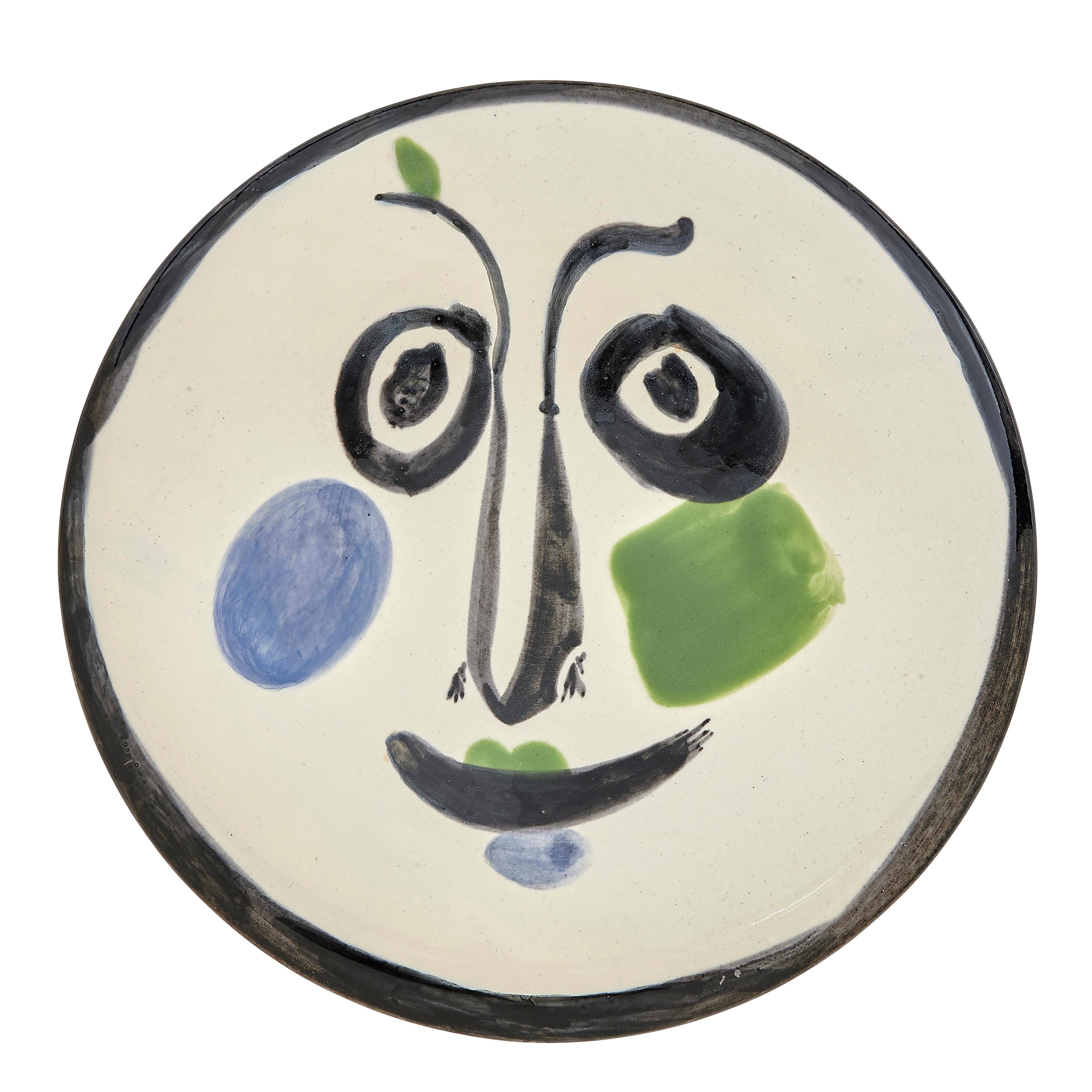 PABLO PICASSO (1881-1973) 
Visage No. 197 (A. R. 494) 

Terre de faïence plate, 1963, numbered 365/500, titled, inscribed 'Edition Picasso' and 'Madoura', glazed and painted