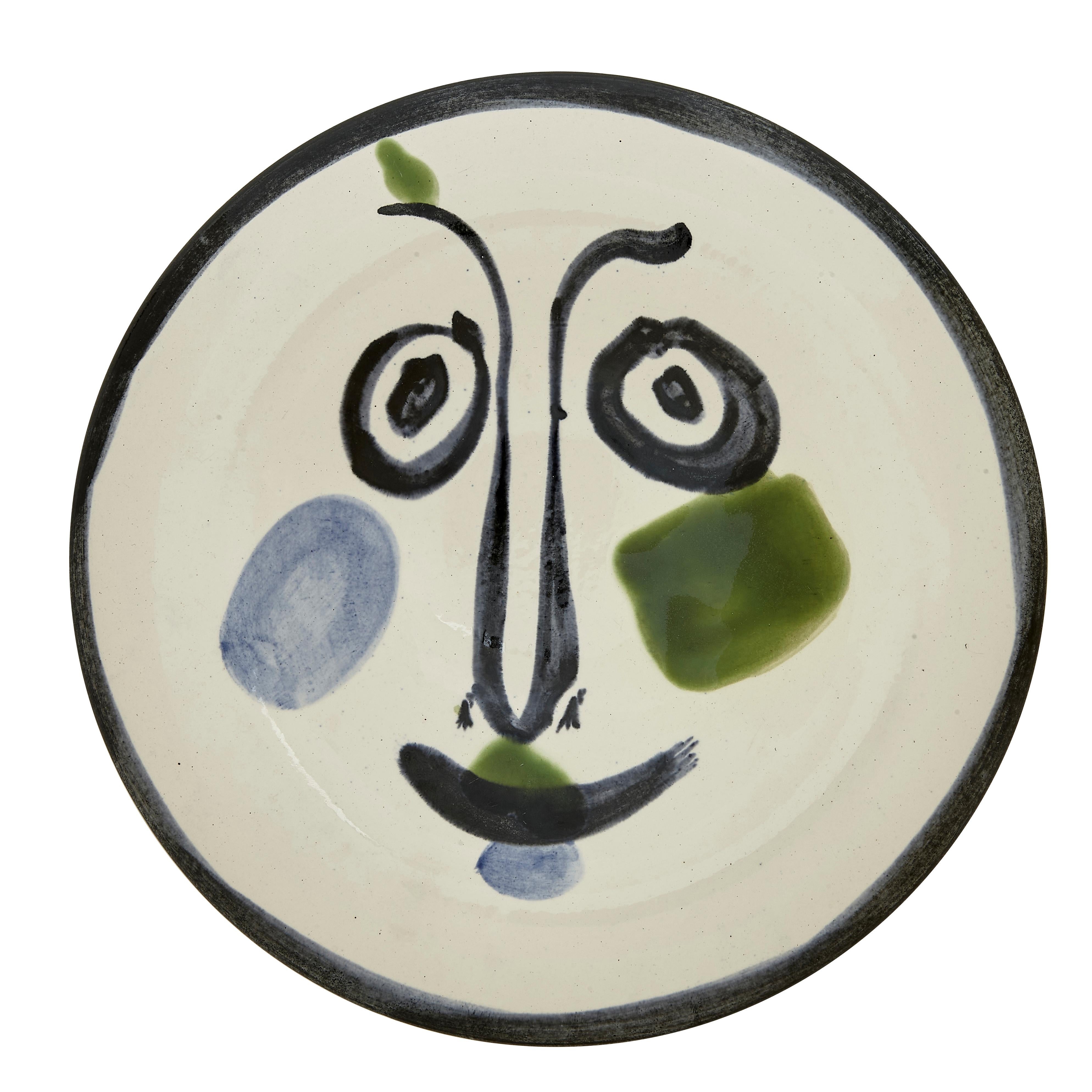 PABLO PICASSO (1881-1973) 
Visage No. 197 (A. R. 494) 

Terre de faïence plate, 1963, numbered 151/500, titled, inscribed 'Edition Picasso' and 'Madoura', glazed and painted