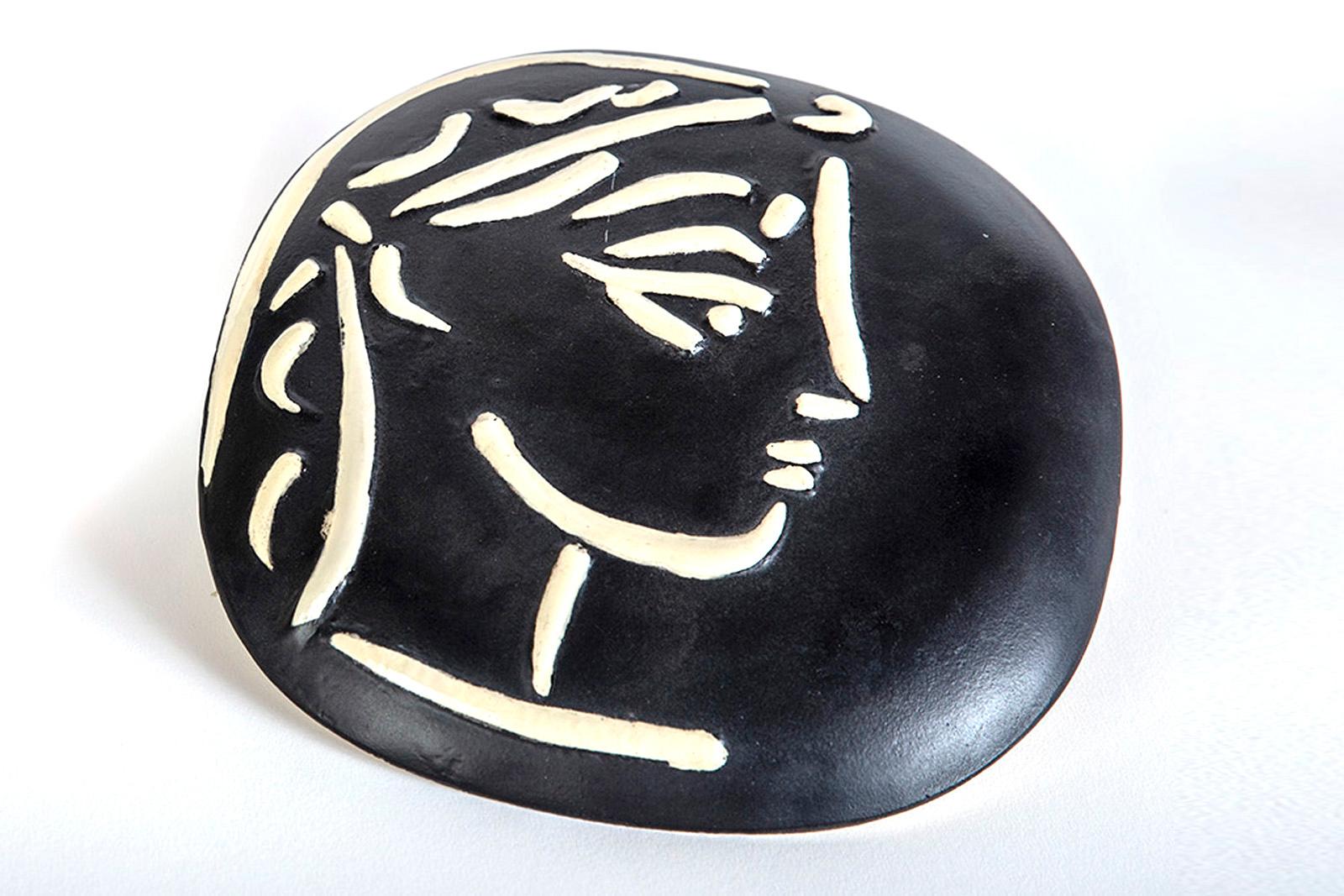 Artist: Pablo PIcasso

Title: Profil de Jacqueline (Jacqueline’s Profile)

Medium: Madoura convex wall plaque of white earthenware clay, engraving accentuated with glaze, black patinated ground (ivory, brown)

Size: 7 1/4"

Edition: 500 limited