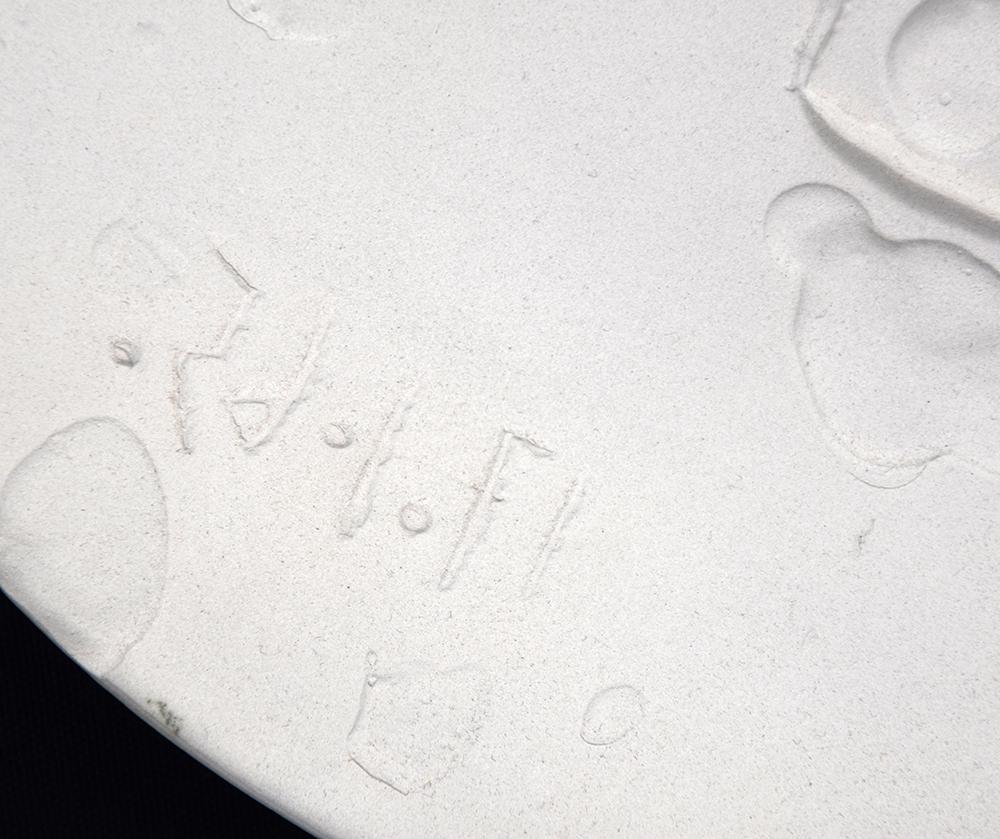 Created in 1965, this Madoura round dish of white earthenware clay is numbered from the edition of 100 on verso. This work is stamped with the ‘EMPREINTE ORIGINALE DE PICASSO’ and ‘MADOURA PLEIN FEU’ pottery stamps on verso.

A smiling face stares