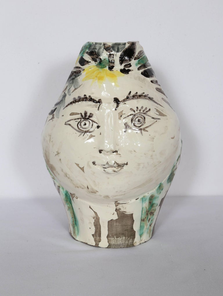 Artist: Pablo Picasso, Spanish (1881 - 1973)
Title: Woman's Head, Decorated with Flowers (Ramie 237)
Year: 1954
Medium: A.R. White Earthenware Clay Ceramic Pitcher, numbered on bottom
Edition: 12/100
Size: 9  x 5.5  x 6 in. (22.86  x 13.97  x 15.24