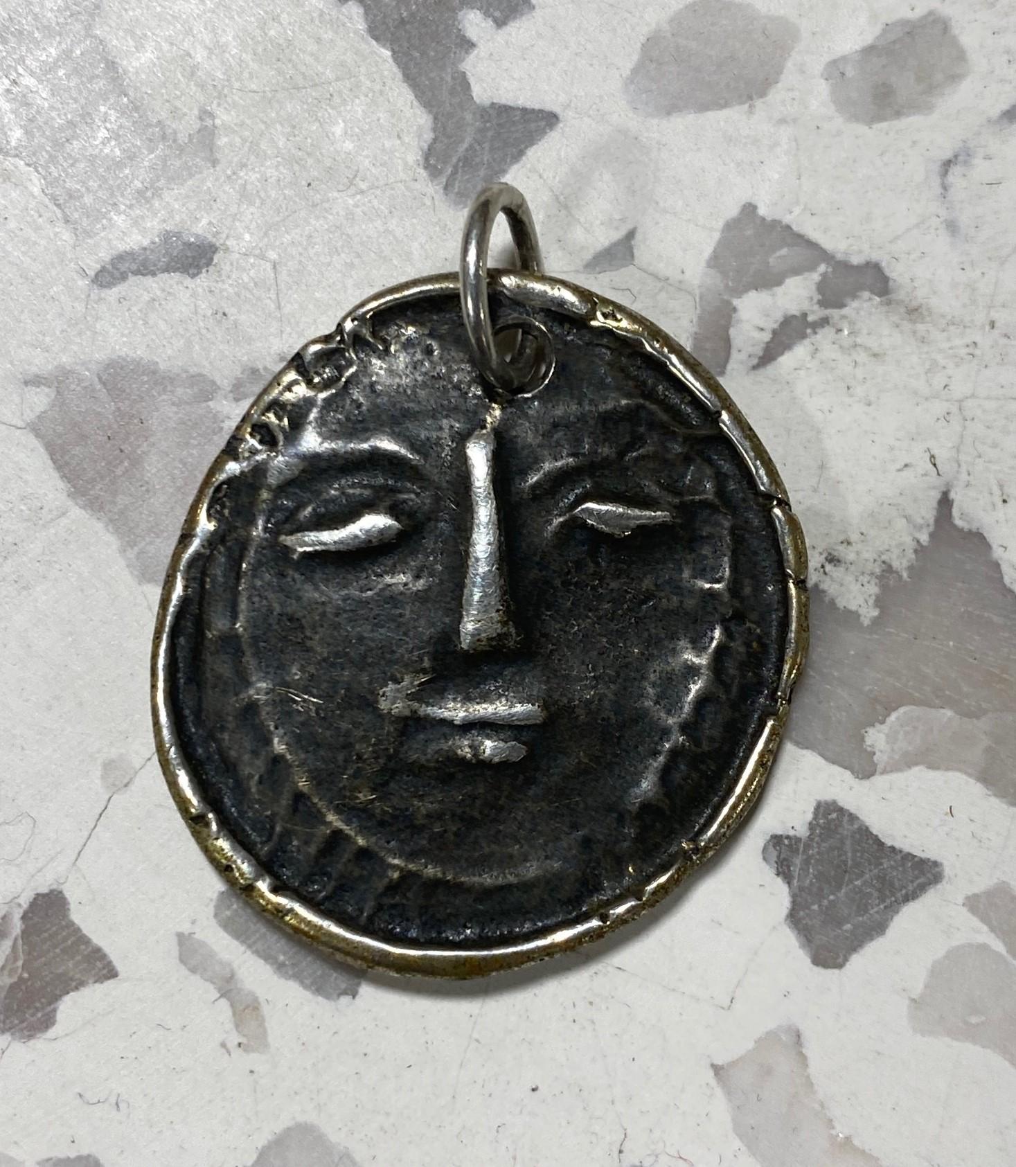 A wonderful and relatively rare Pablo Picasso silver Visage de Femme or Sun pendant/ medallion. Picasso created the piece at Madoura in Vallauris, Southern France in 1949. 

Signed/ Stamped by Picasso on the verso 