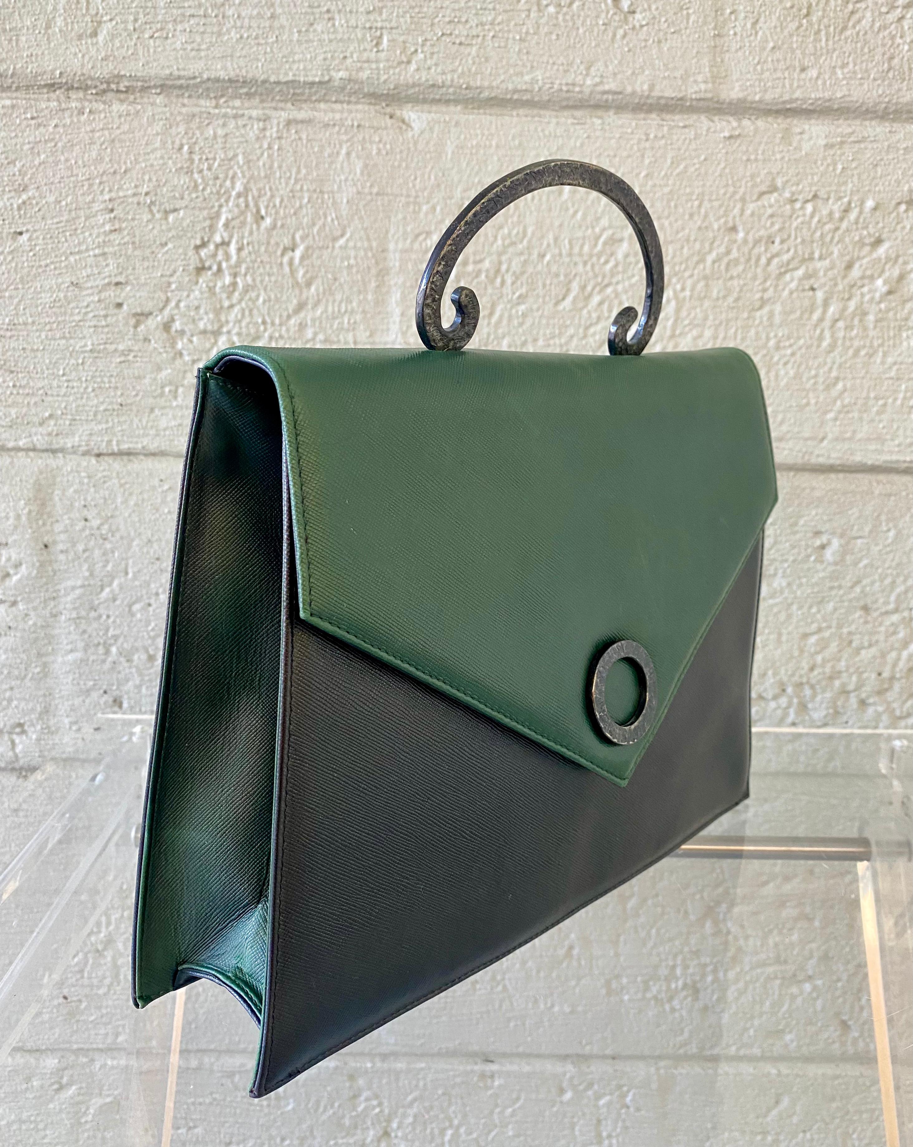 The Vintage Kelly Flap style bag from Pablo Picassi is one of the famed luxury goods house's most coveted and exclusive items. This flap bag is made of black and green leather. Black leather lining. Open interior back exterior pockets.compartments.