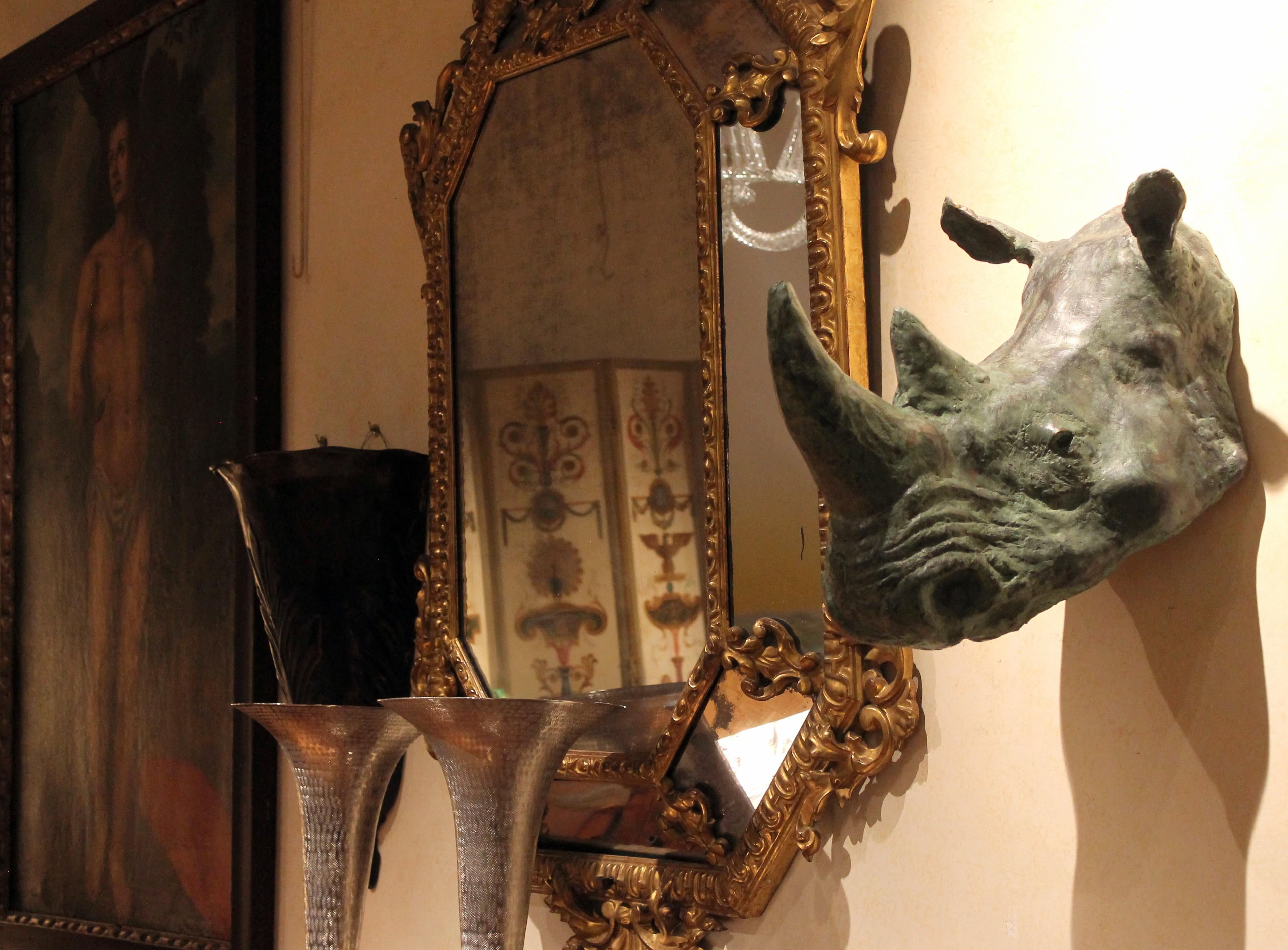 This contemporary bronze sculpture of rhinoceros head faithfully reproduces – in almost real size - one of the largest mammals in the world. Proud and mighty, this rhino trophy head sculpture with green patina finish is a powerful interior statement