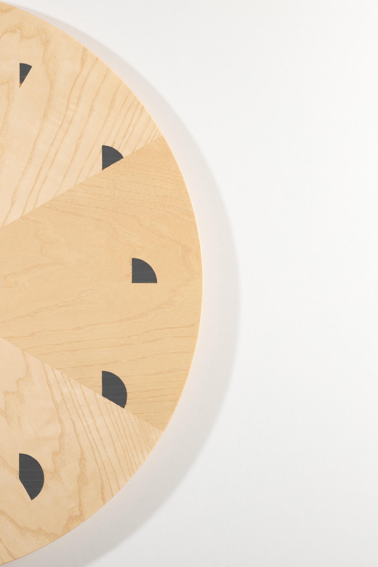 Transform your space with these enchanting wall clocks that effortlessly combine artistry and functionality. The clocks boast a captivating design, featuring a meticulously arranged ash veneer meticulously shaped into a regular form, accentuated by