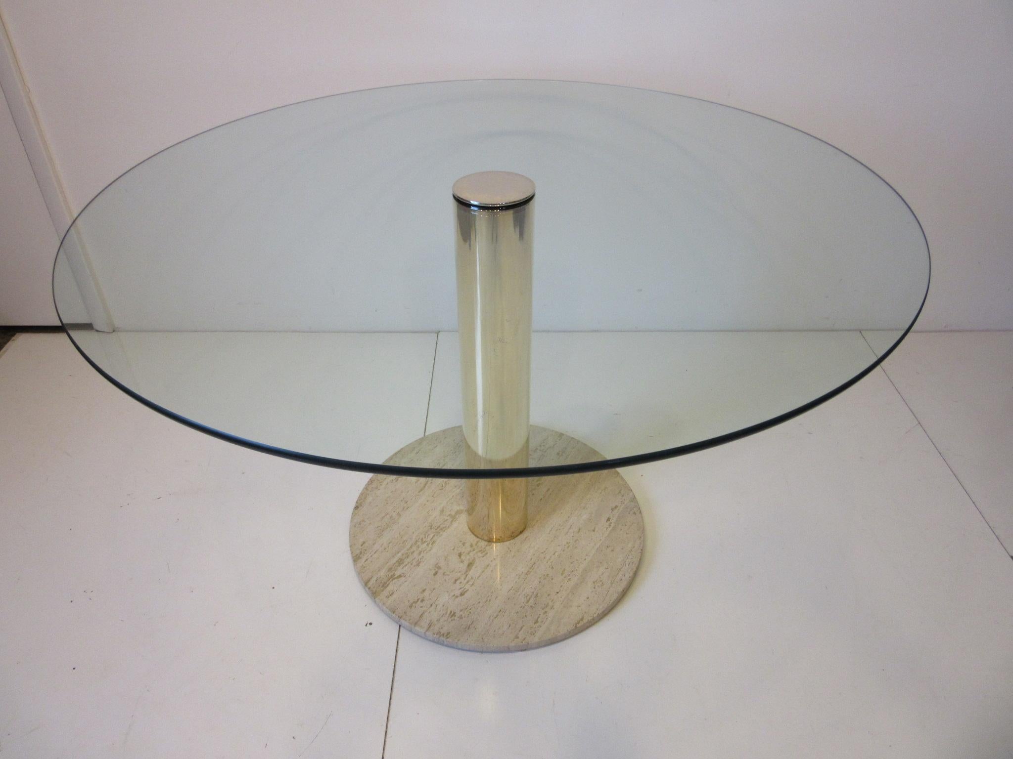 A round glass topped dining table with brass and Italian marble base designed by Leon Pace and manufacture by the Pace Furniture company know for their high quality and a staple of the 1970s and 1980s high end interiors.