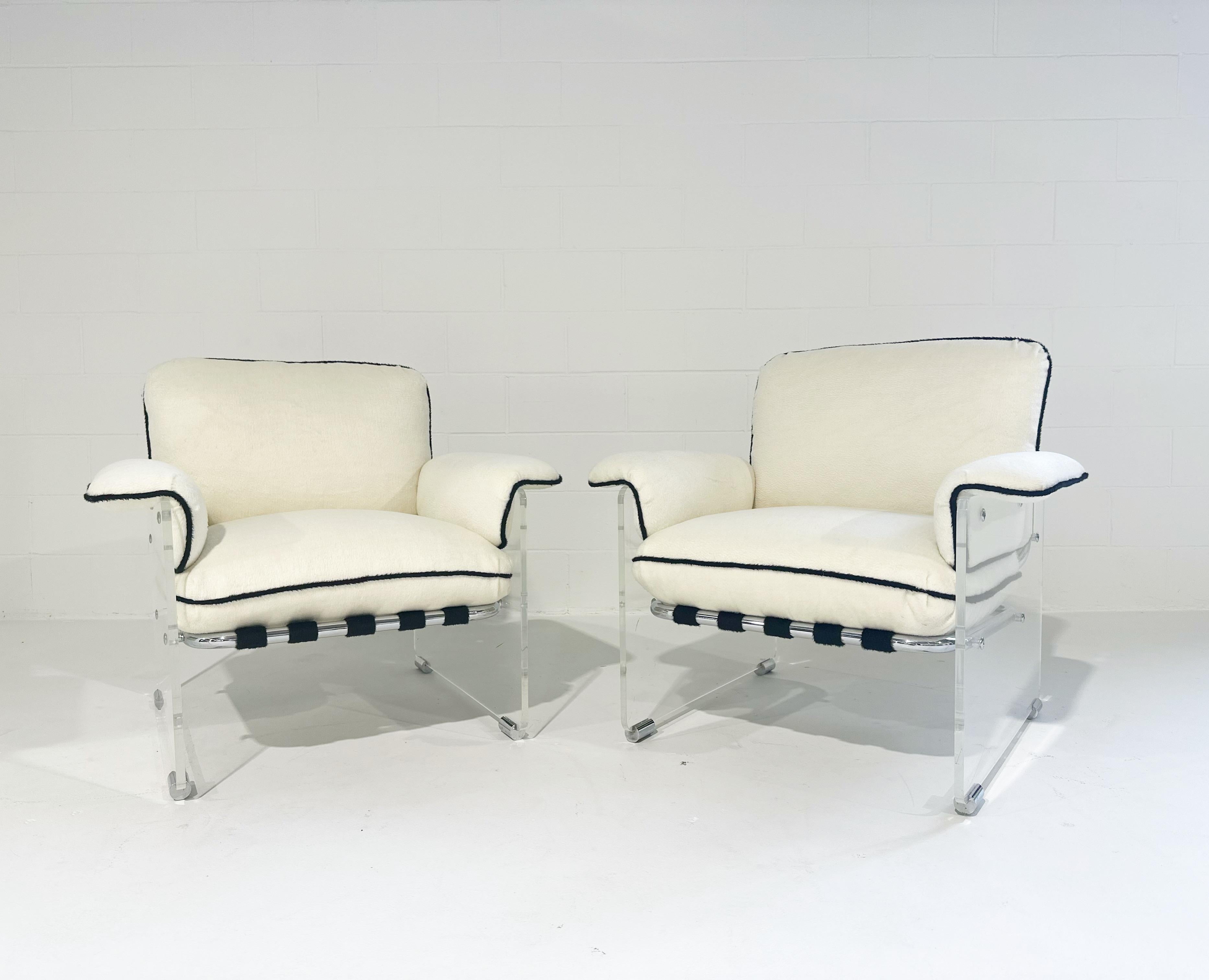 These amazing 1970s Pace Collection lounge chairs feature thick lucite panels with chrome details. Straps wrap the tubular chrome frame to support the cushions. The loose cushions and straps have all been masterfully created and upholstered in a