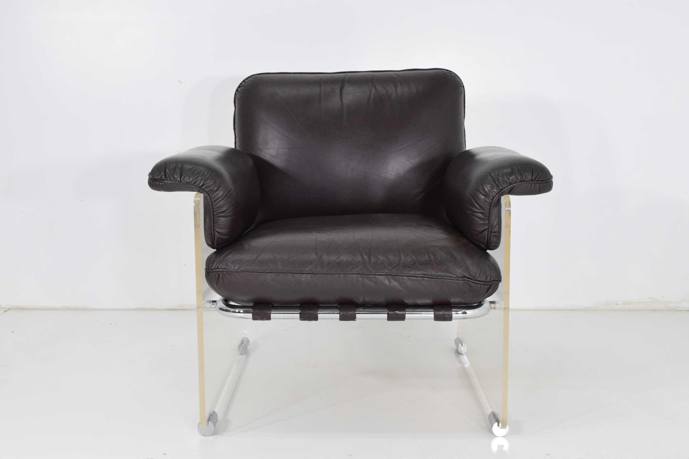 This amazing 1970s pace collection lounge chair feature thick Lucite panels with chrome details. Straps wrap the tubular chrome frame to support the cushions. This chair is upholstered in a leather which is in good condition or it can be