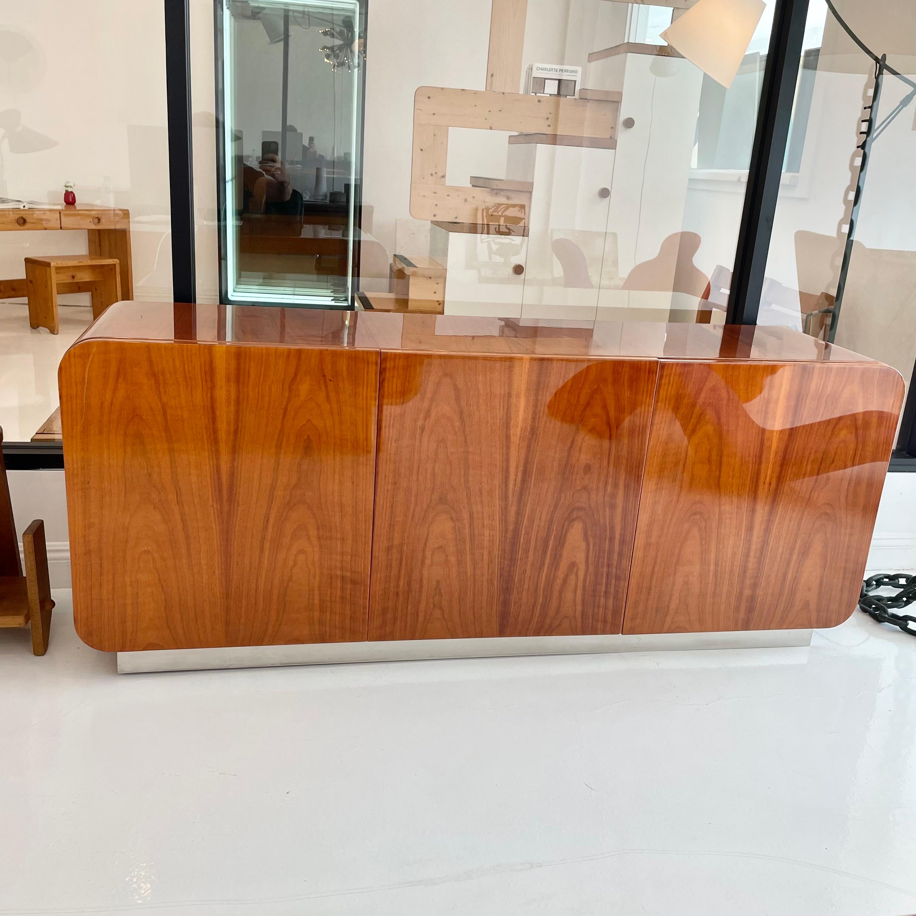 Recently restored and refinished exquisite Pau Ferro hardwood credenza by Irving Rosen for the Pace Collection circa 1974 with rounded waterfall corners and a polished chrome base. 

Stunning grain patterning in the Pau Ferro hardwood with a high