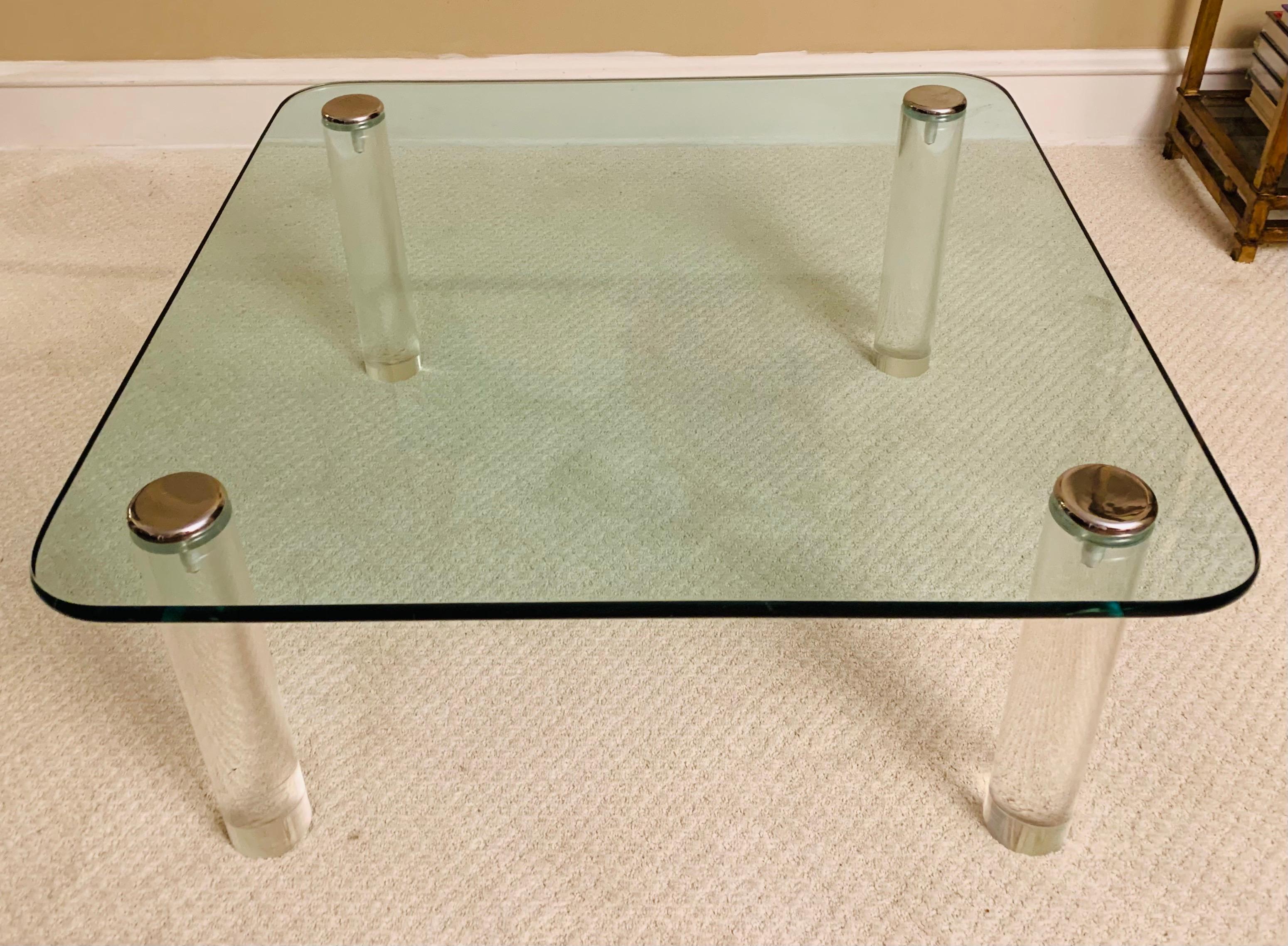 Large Pace Collection cocktail table with thick Lucite cylindrical legs. 

Chrome is in extremely good condition, as is glass top. 

Sleek and unobtrusive, it's hard not to love this piece.