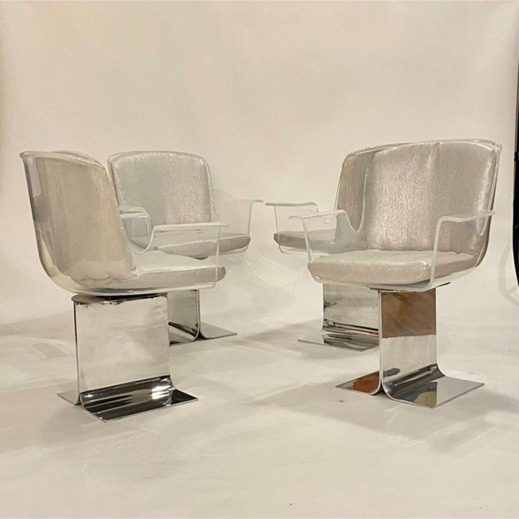 Set of four Pace collection Lucite swivel arm chairs on polished chrome I-beam bases, designed by Leon Rosen. Newly upholstered cushions in a textured platinum fabric.

Additional Information:
Materials: Lucite, Aluminum
Color: Transparent,