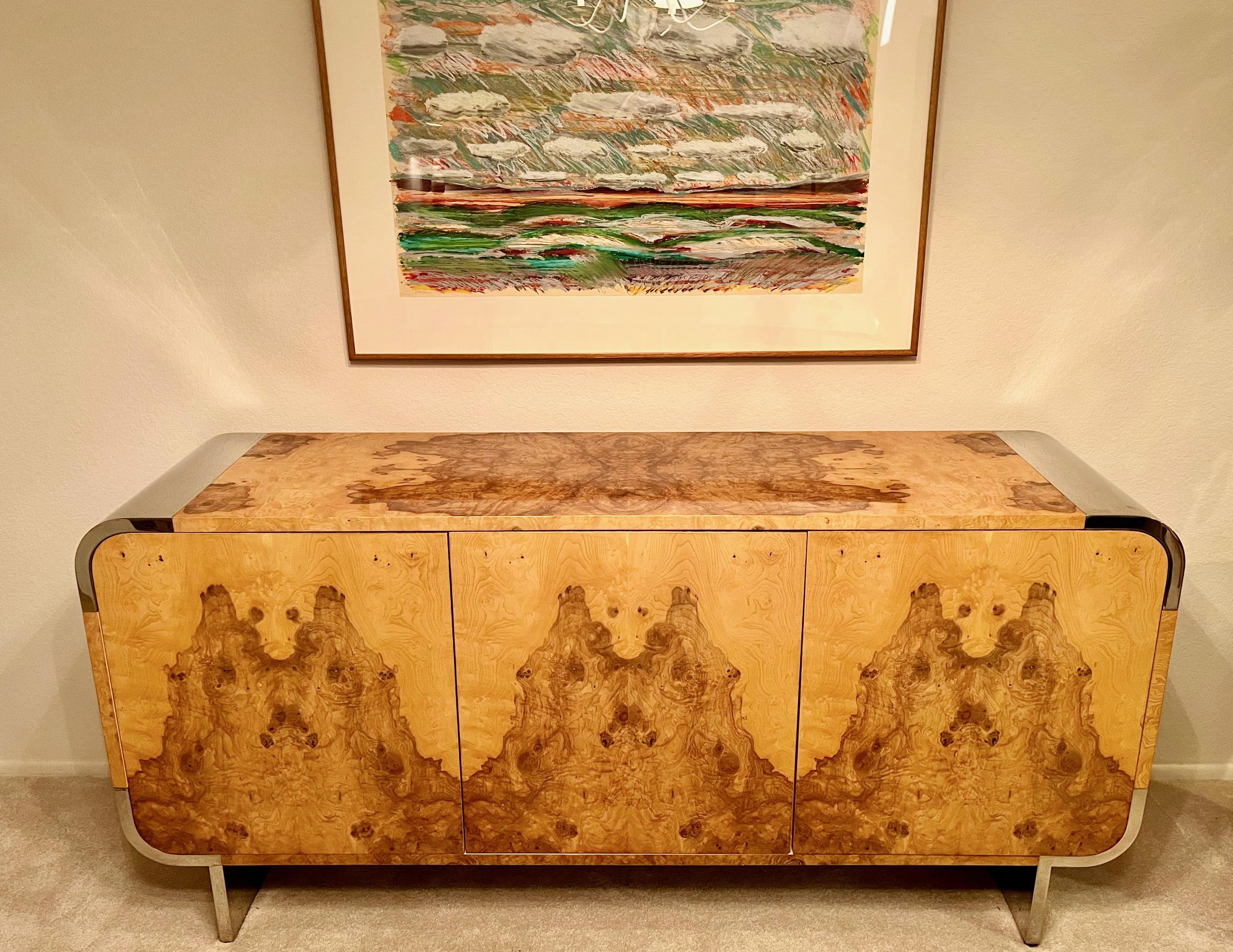 Pace Collection olive burl model 8800 sideboard designed by Irving Rosen.
Measures: 74 inches long x 19 inches deep x 35.5 inches high.
Mirror polished stainless steel radial corners and legs (7