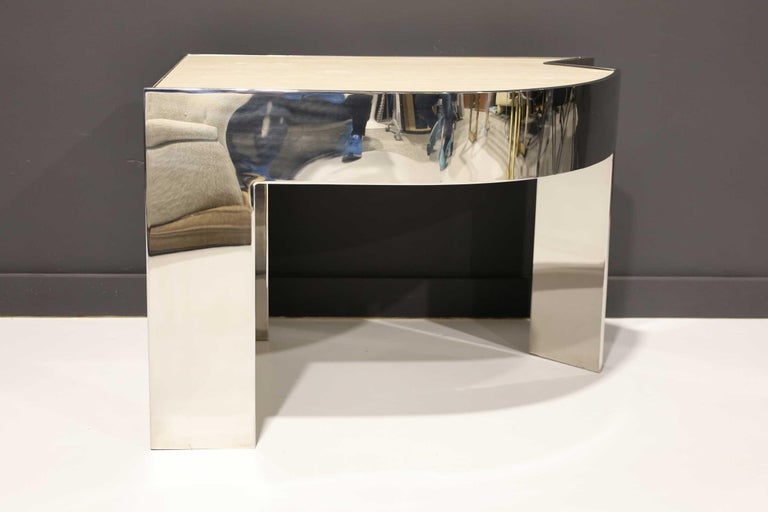 A rare side table by Pace Collection, similar in style to its Mezzaluna desk and part of same collection. It is polished steel with a marble top inserted. You can see the quality craftsmanship in the edges and corners and how the travertine fits